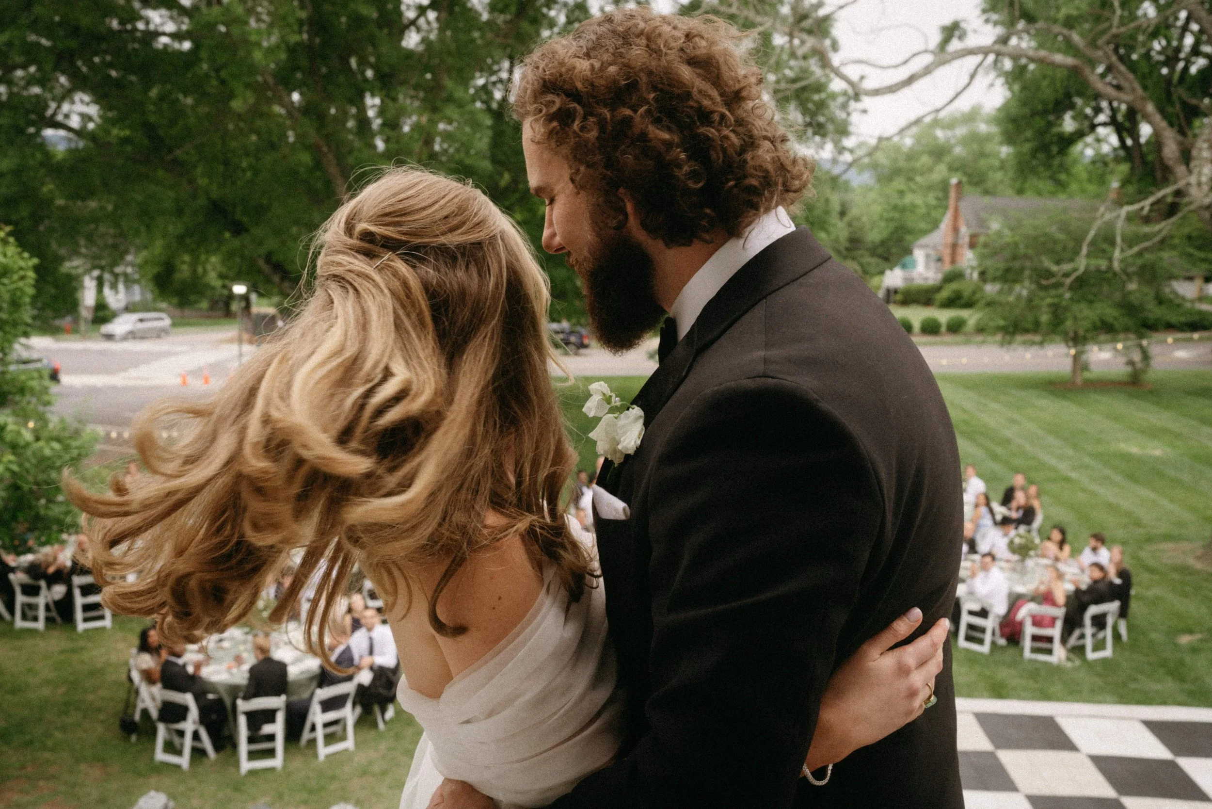 wedding couple overlook outdoor reception editorial style
