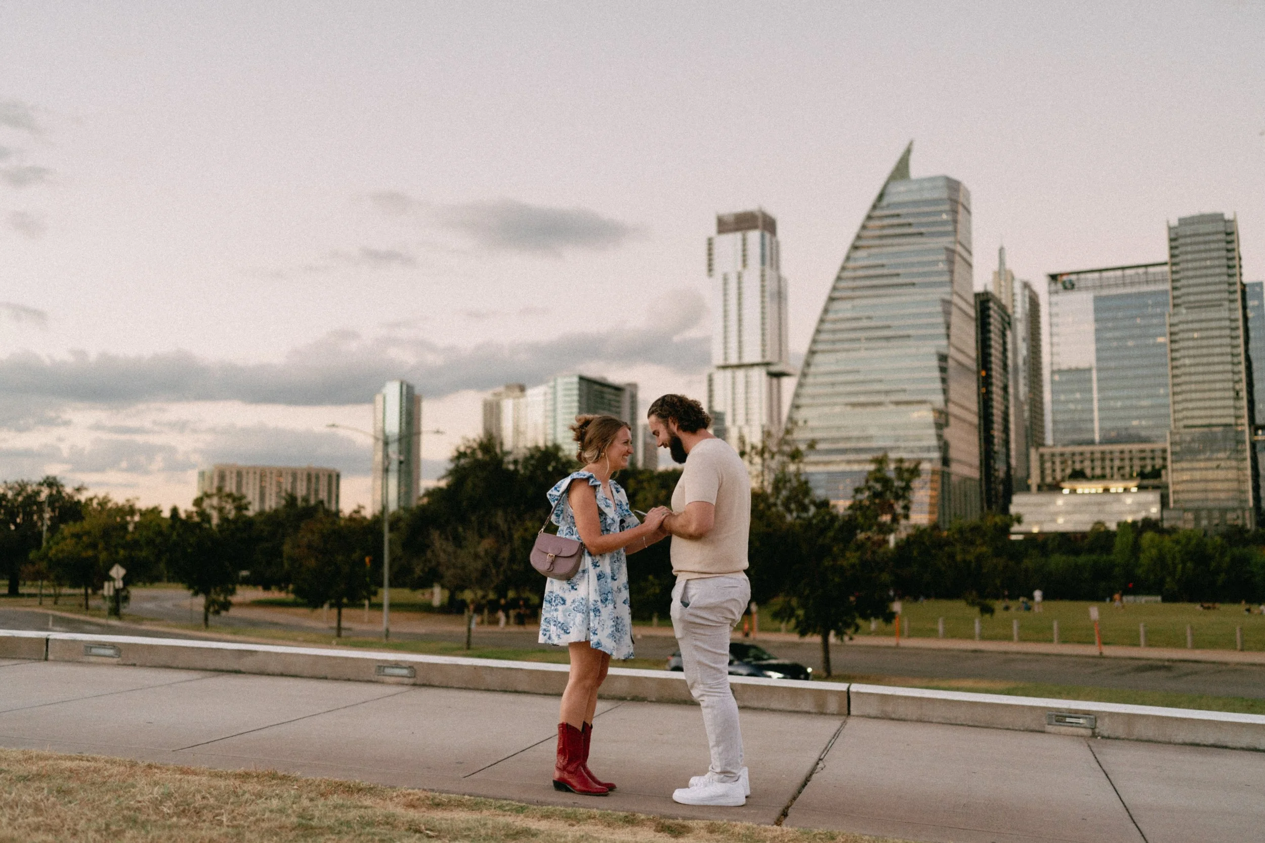 Sunset proposal at Auditorium Shores in Austin captured by documentary style wedding photographer