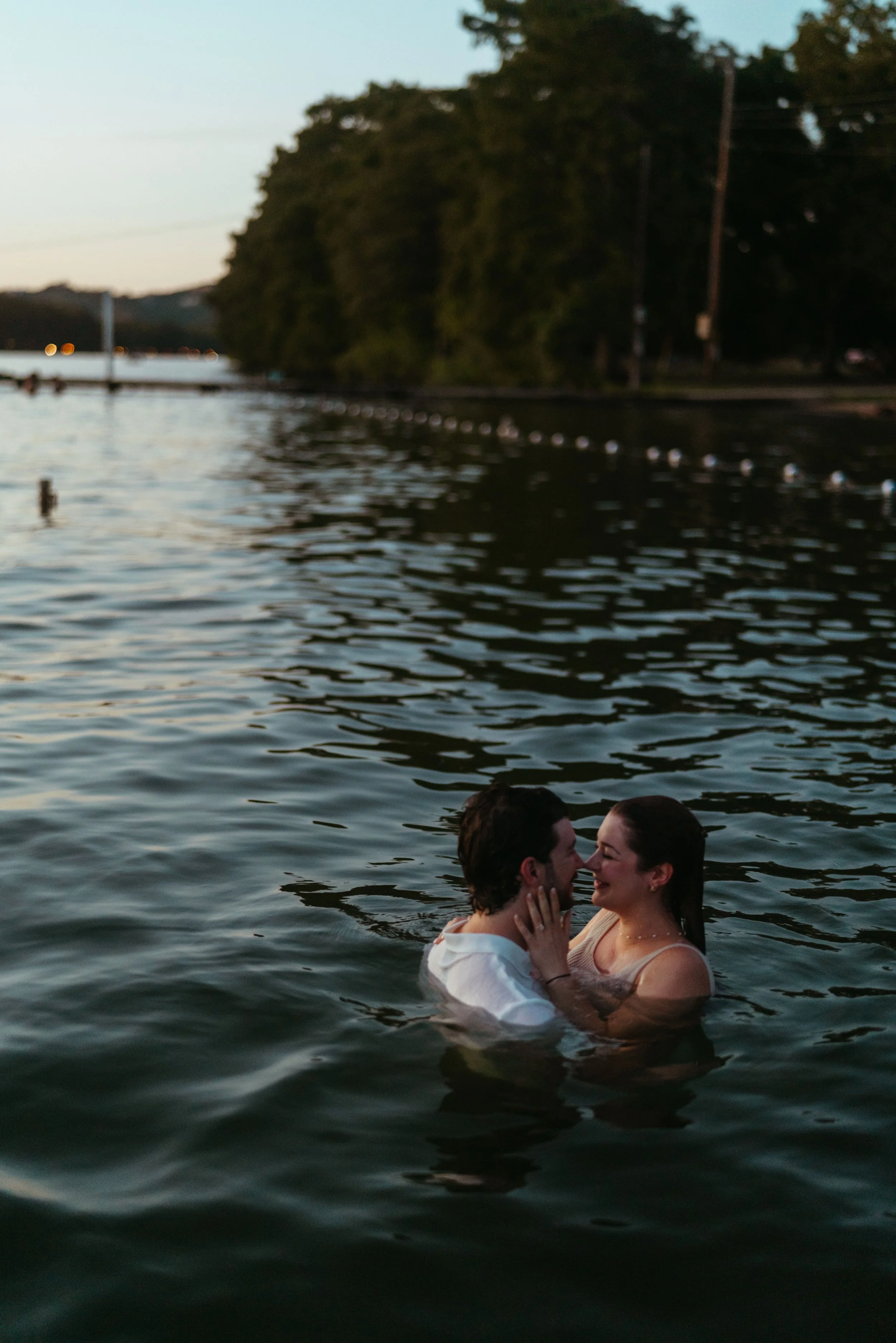Playful Austin engagement photography with couple celebrating in the water