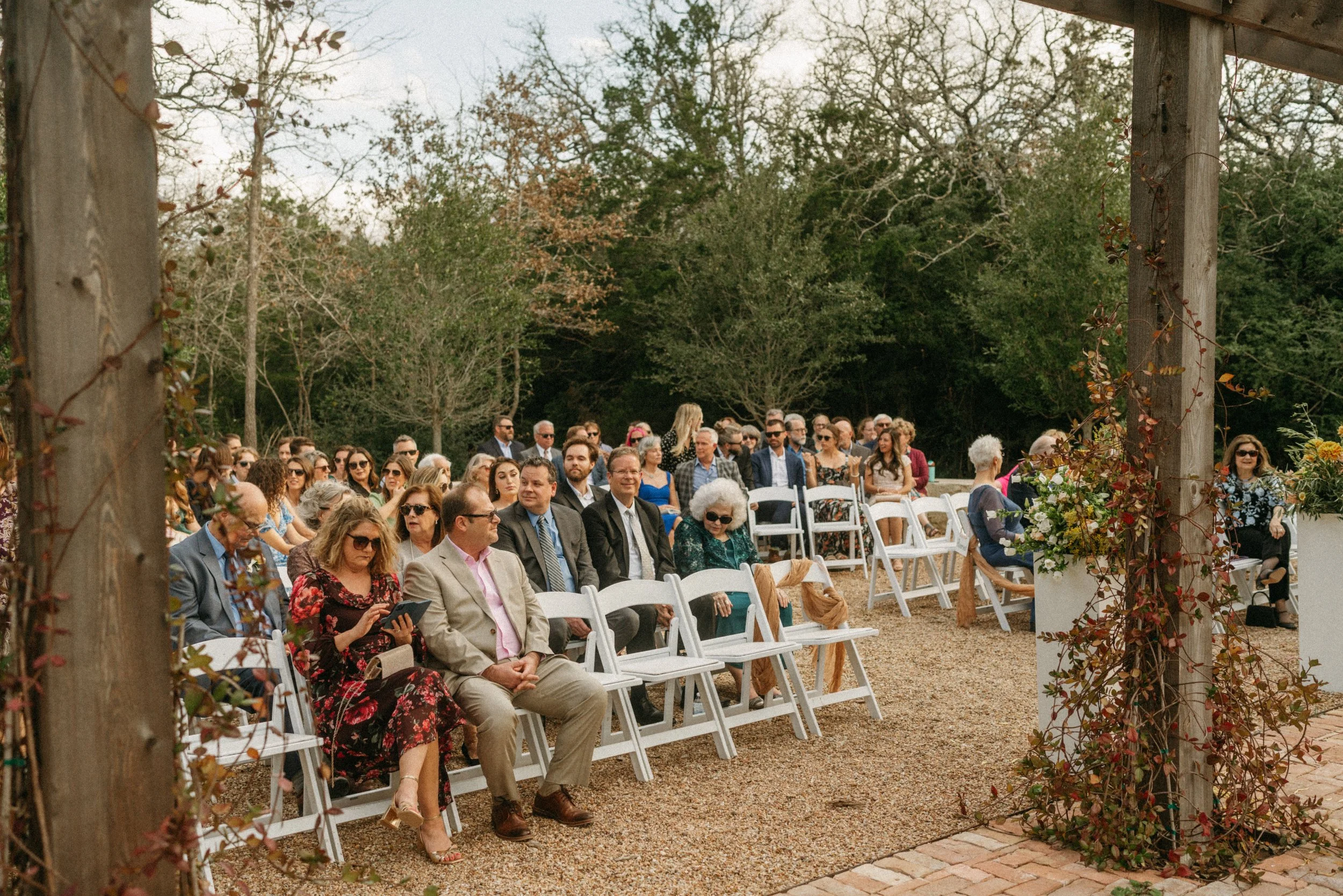 Guests watching a romantic flower garden ceremony at The Grand Lady wedding venue near Austin