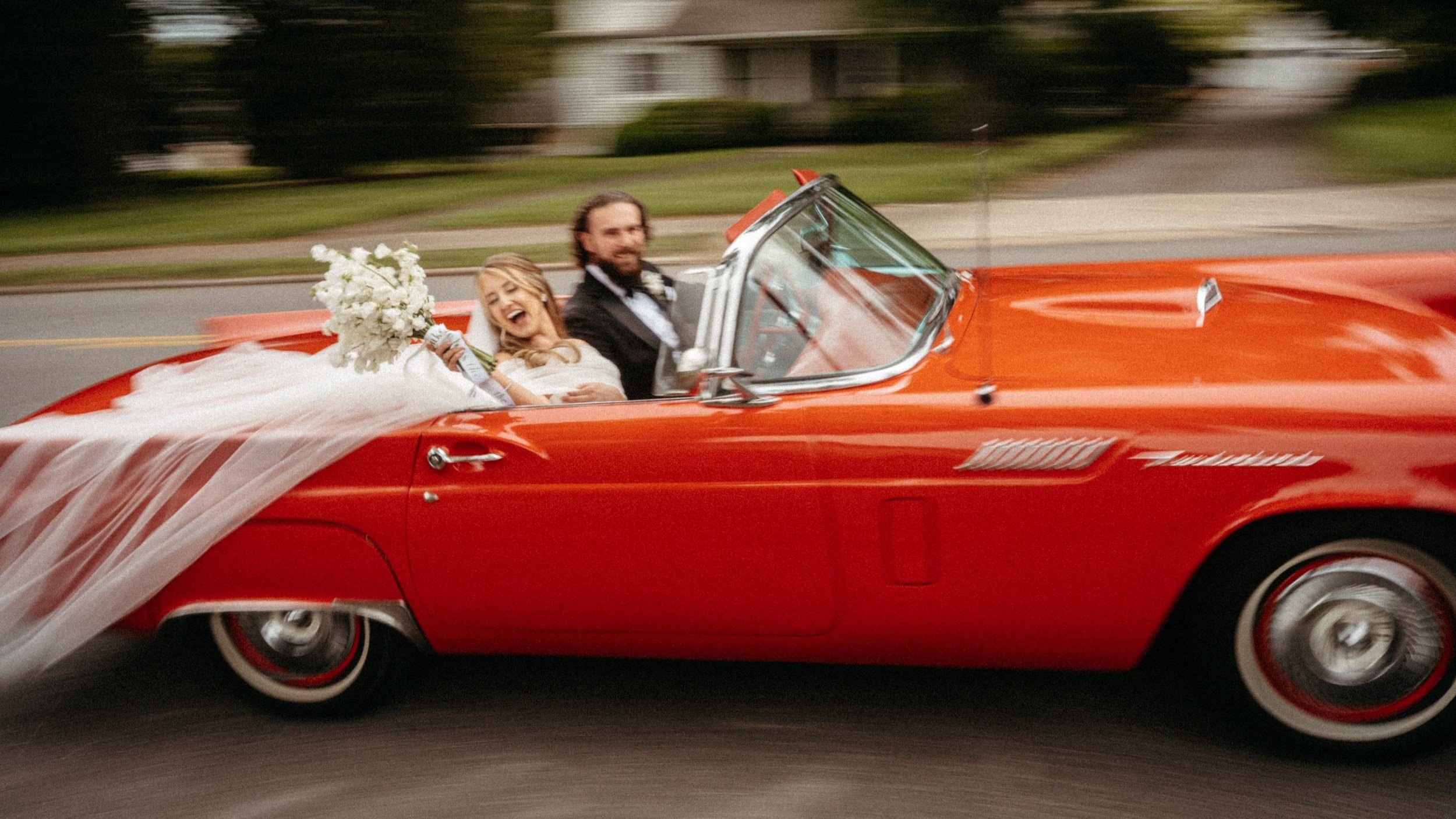 Blurry motion shot of bride and grooms grand exit from their wedding ceremony