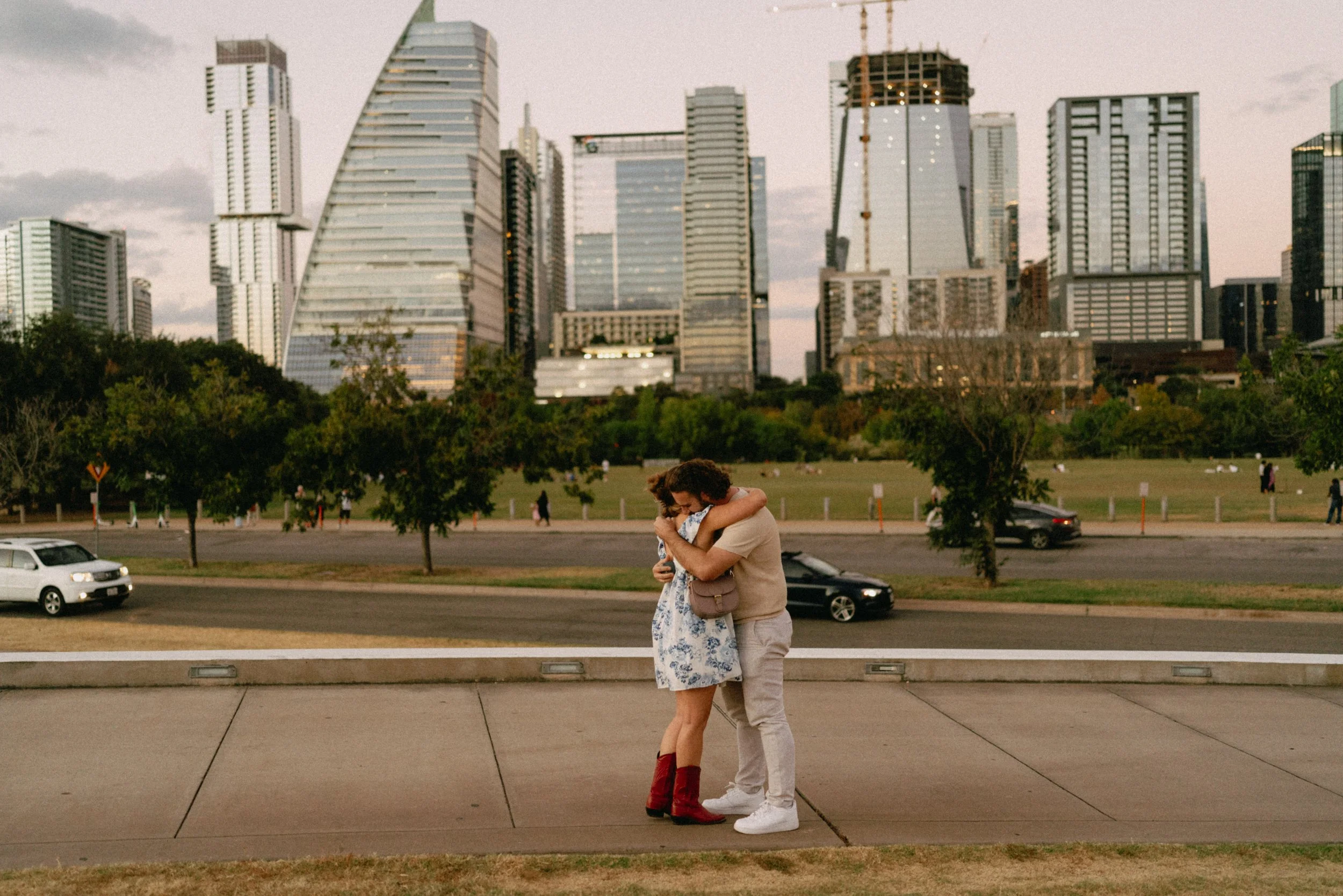 Groom proposing with downtown Austin skyline glowing in the background