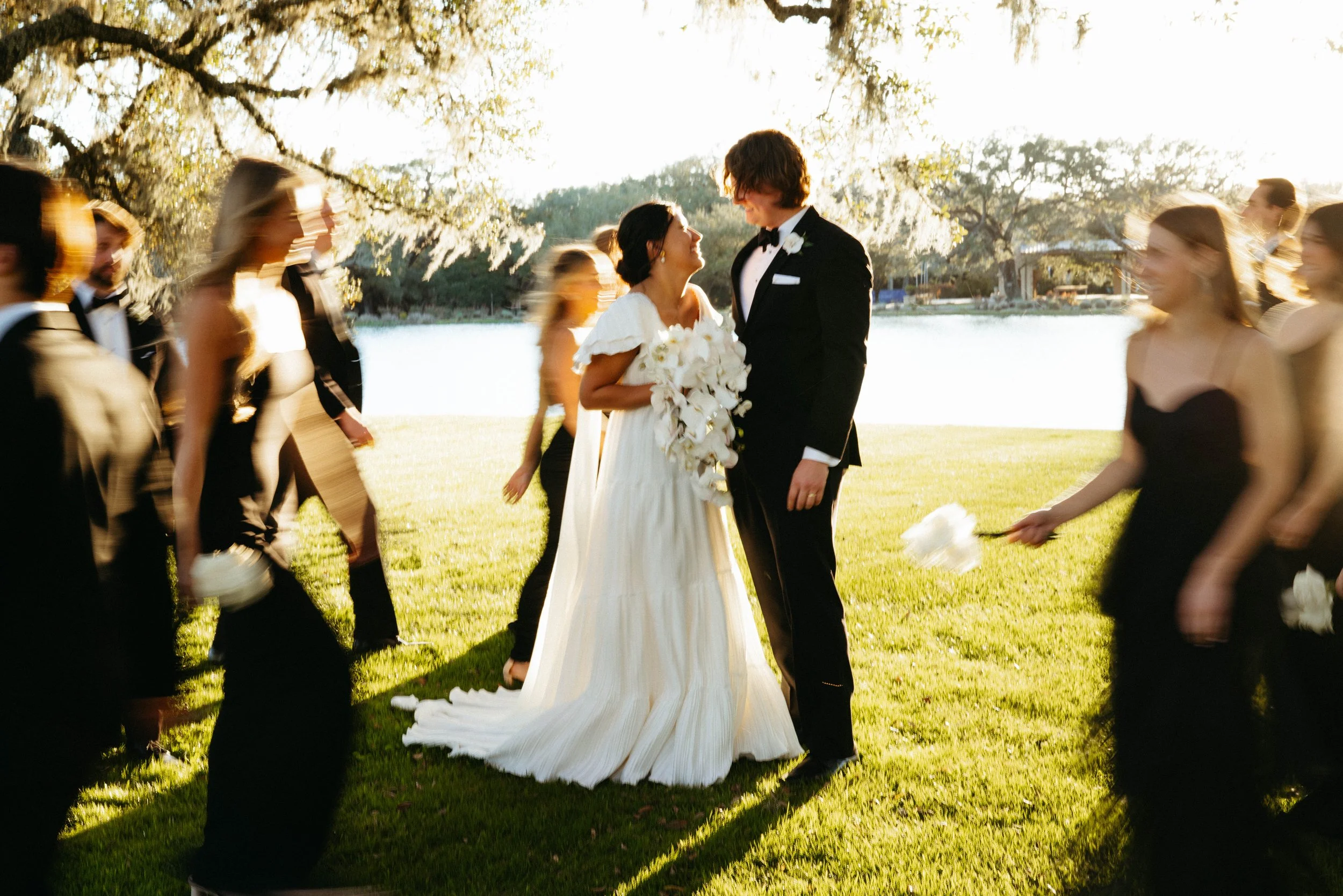 Newlyweds walking hand in hand near the historic French chapel | Austin travel wedding photographer.
