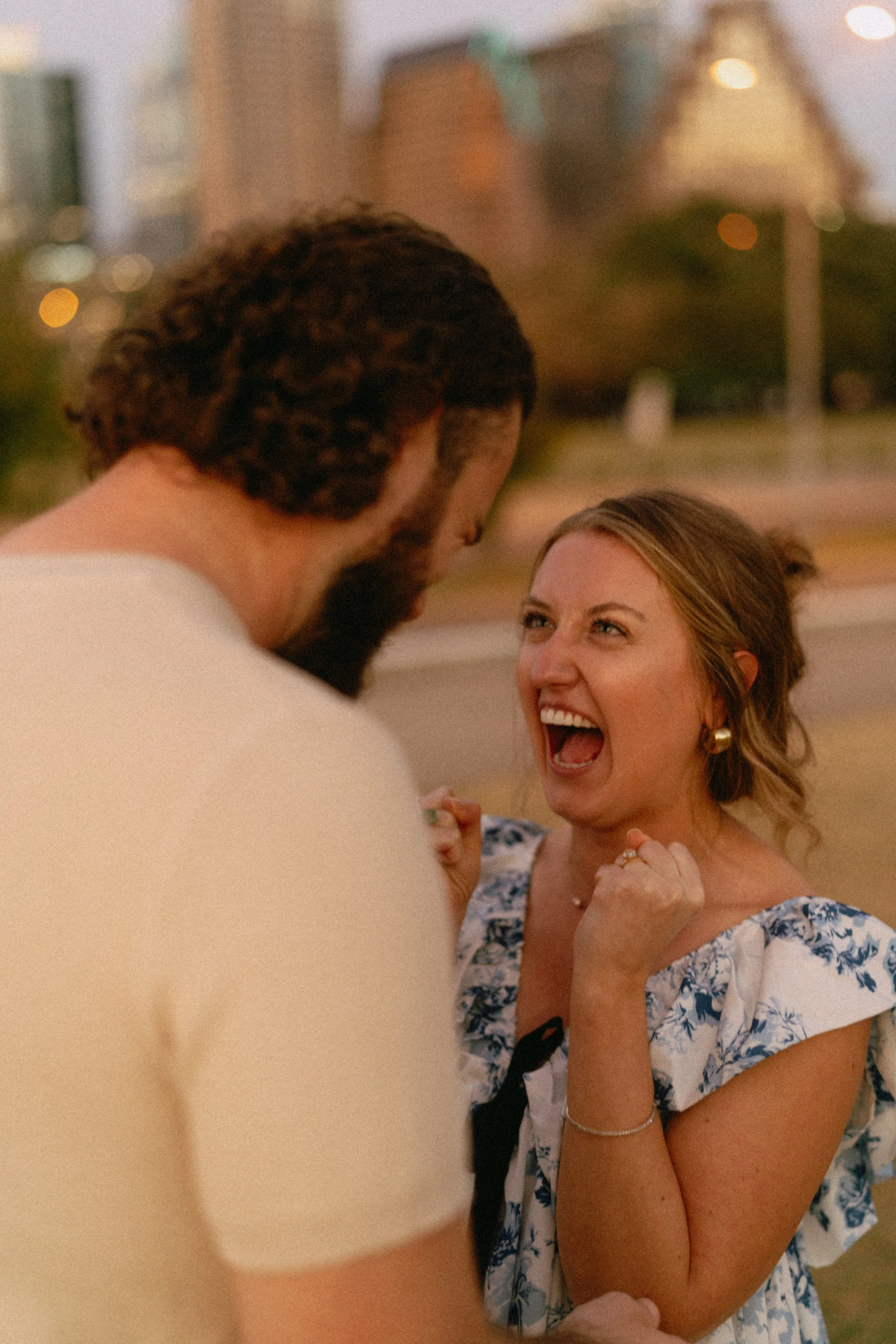 Bride-to-be surprised during proposal at Auditorium Shores with Austin skyline