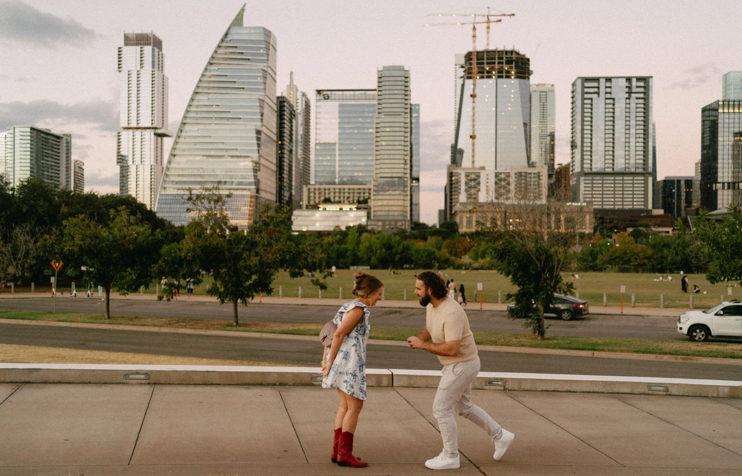 Romantic Austin proposal at Auditorium Shores with skyline at sunset captured by wedding photographer