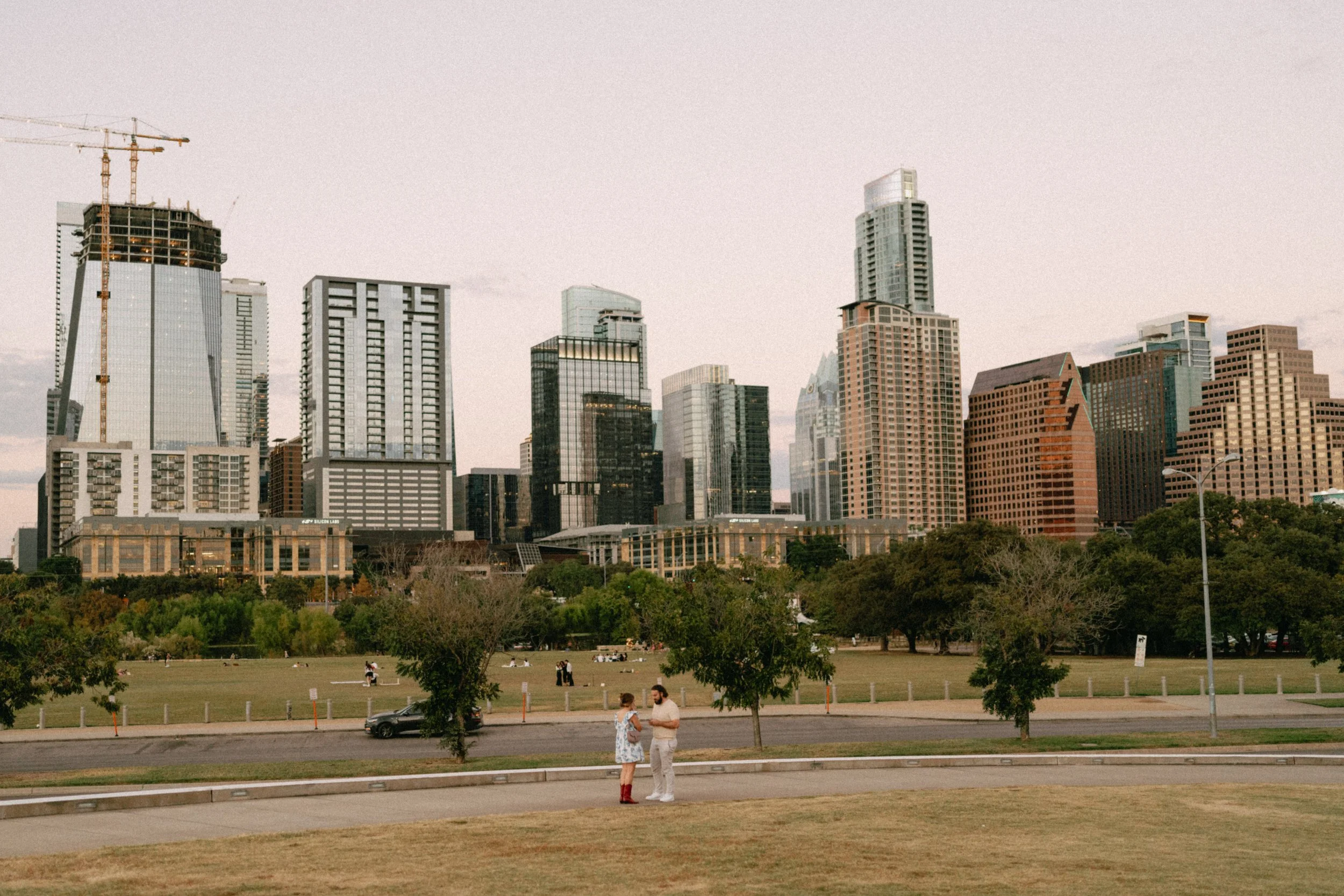 Romantic Austin proposal at Auditorium Shores with skyline at sunset captured by wedding photographer