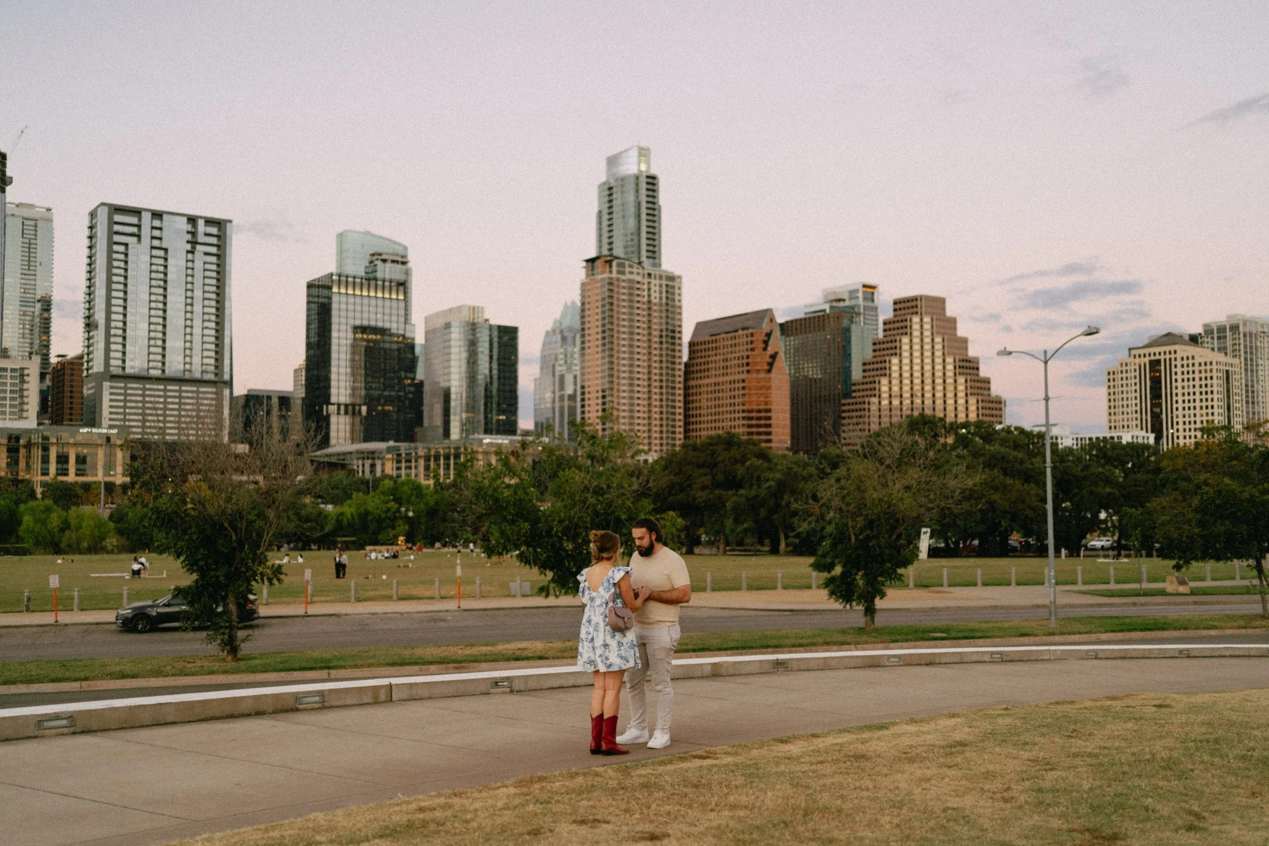 Groom proposing with downtown Austin skyline glowing in the background