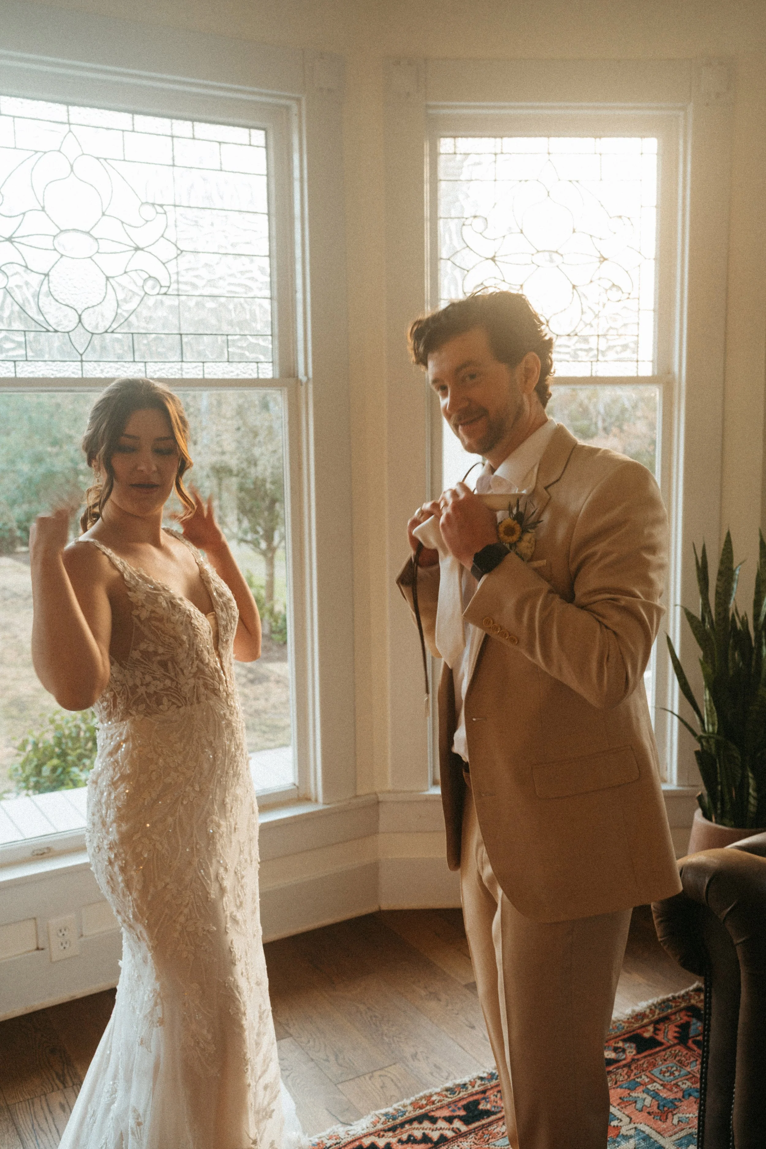Couple exchanging wedding gifts by the grand windows at The Grand Lady in Austin