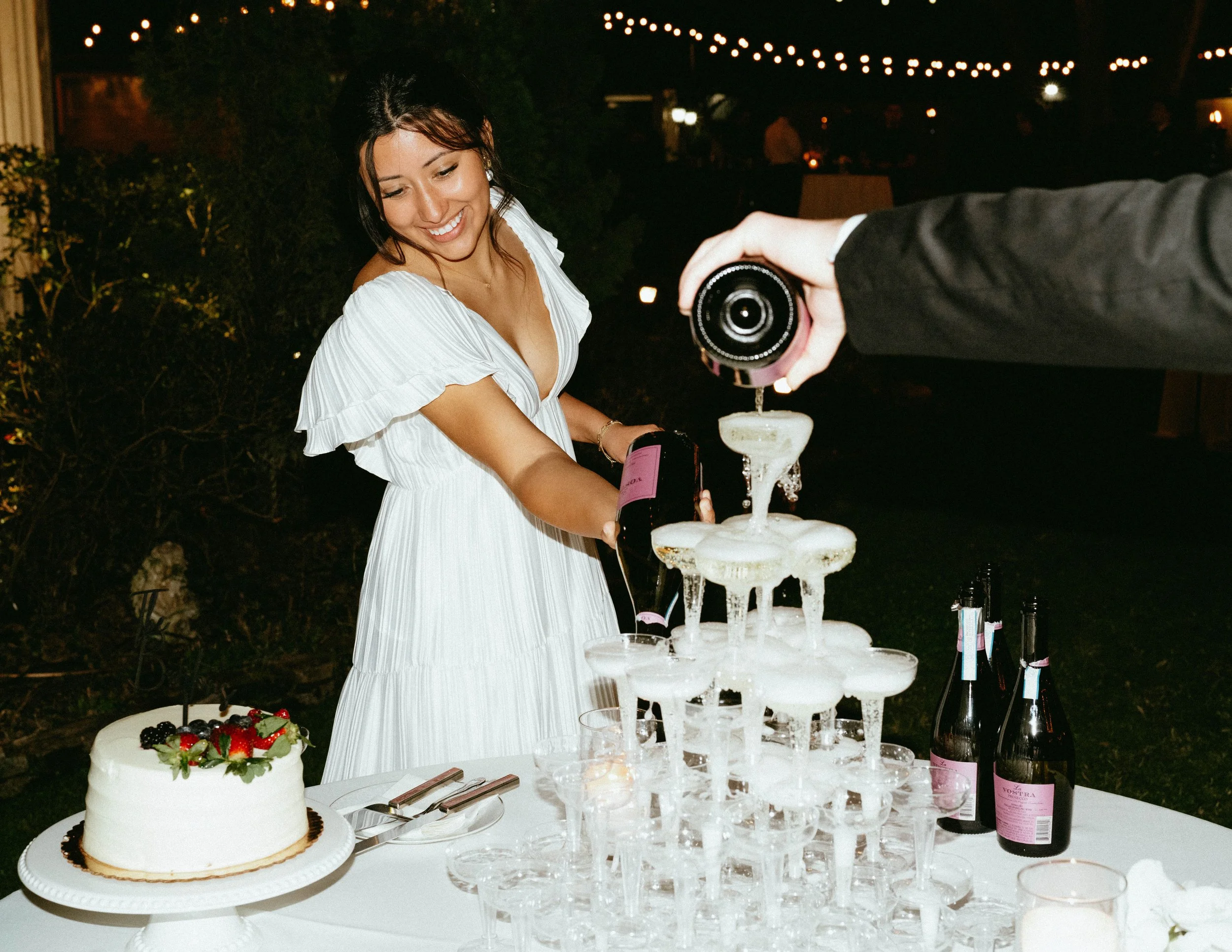 Houston Bride pouring champagne tower at oaktree manor