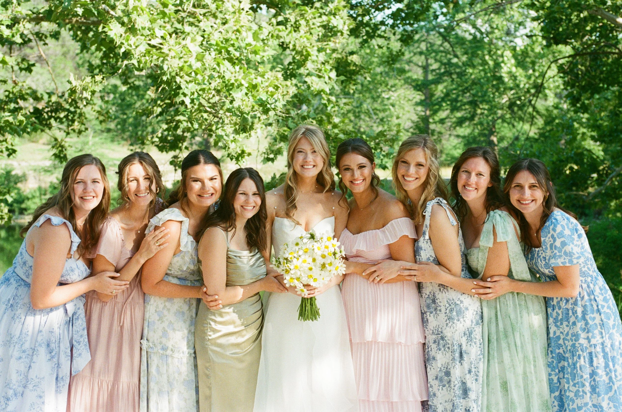 Group photo of bridesmaids with sweeping Canyon Lake views behind them at Austin TX wedding