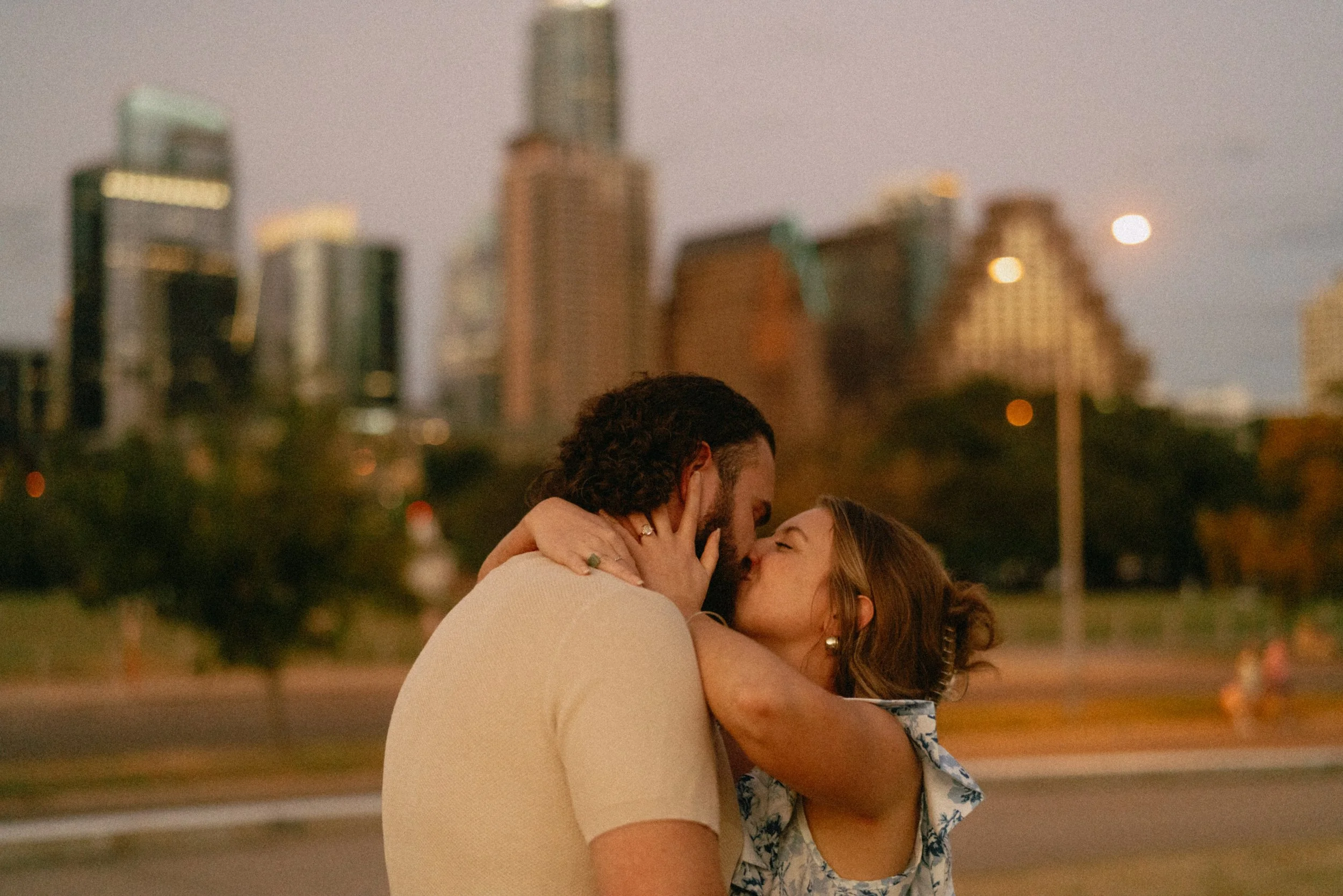 Bride-to-be surprised during proposal at Auditorium Shores with Austin skyline