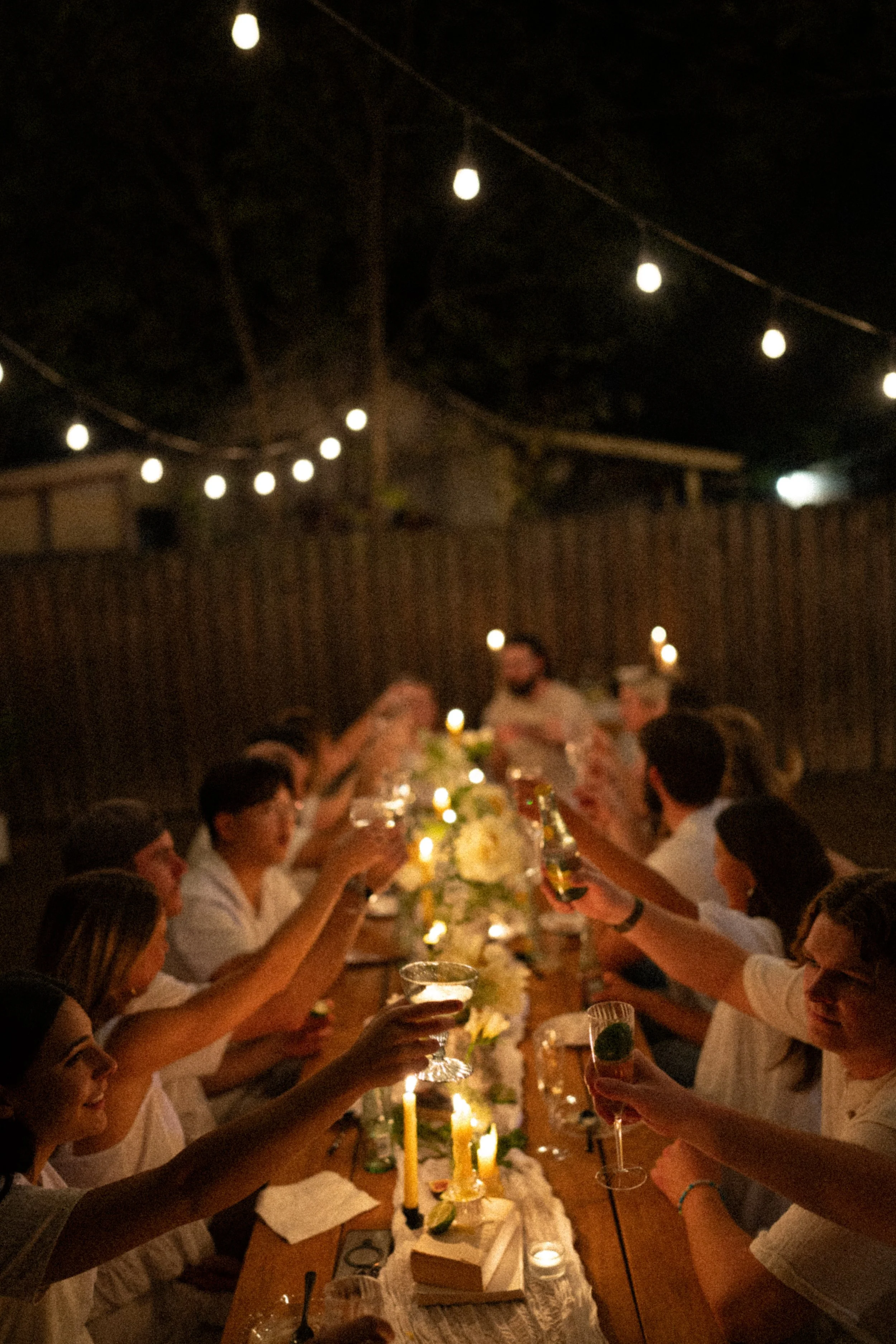 Documentary style wedding photography of couple celebrating engagement with loved ones