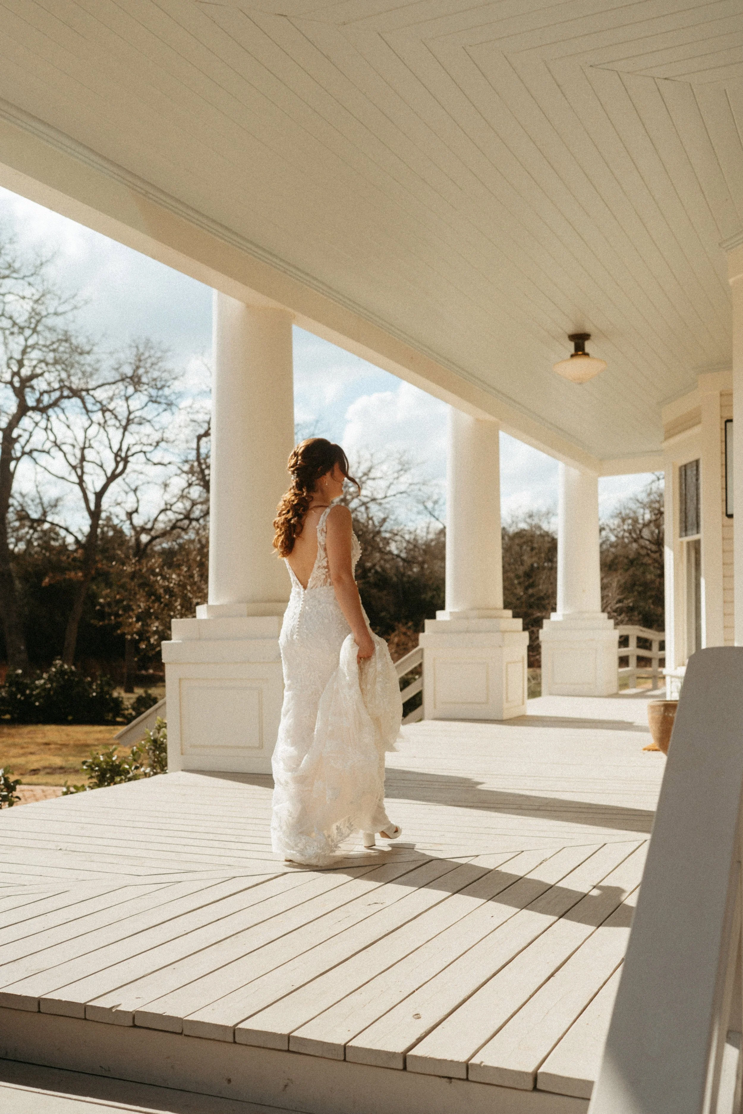 Bride on the porch of the mansion at The Grand Lady Austin wedding