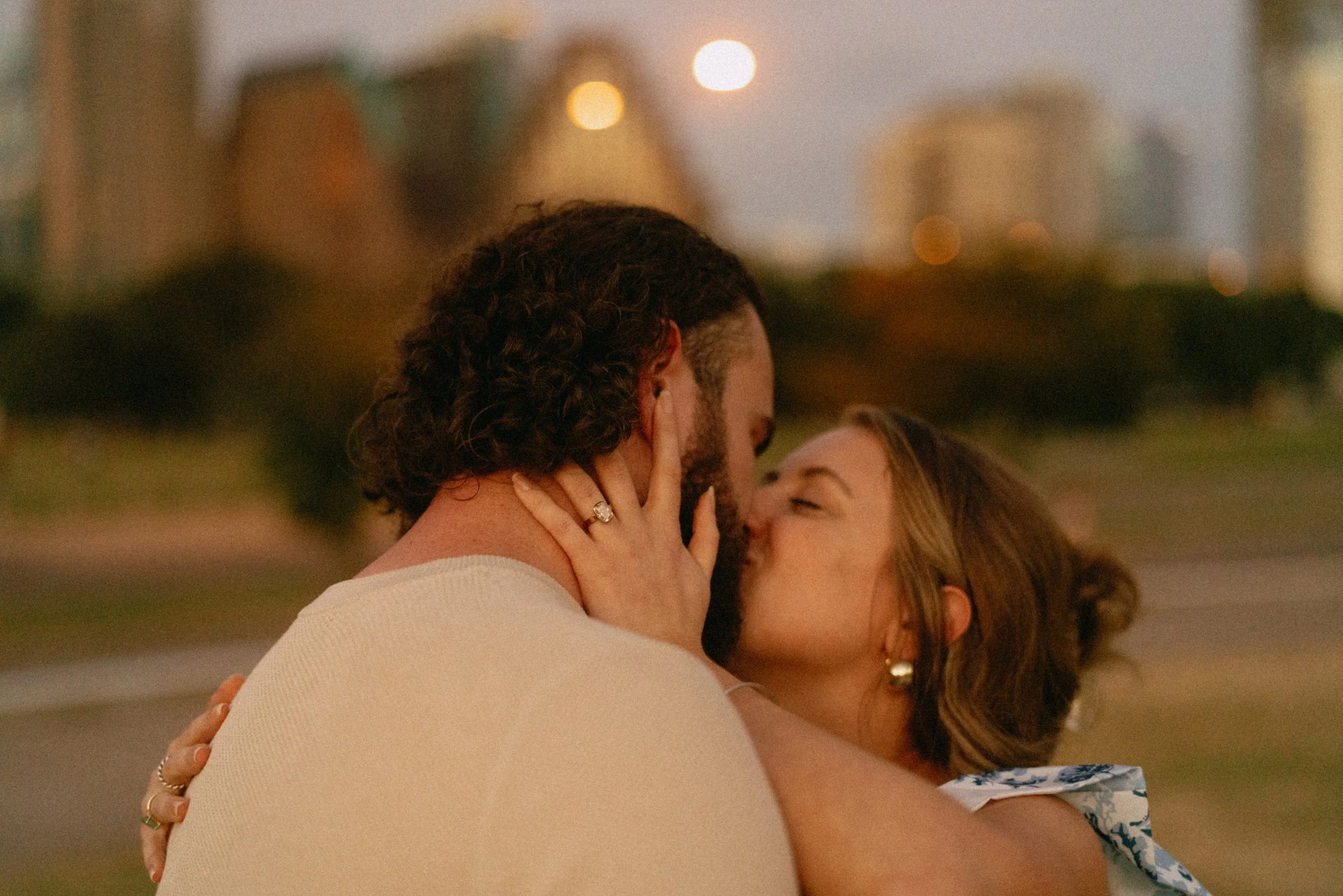Bride-to-be surprised during proposal at Auditorium Shores with Austin skyline