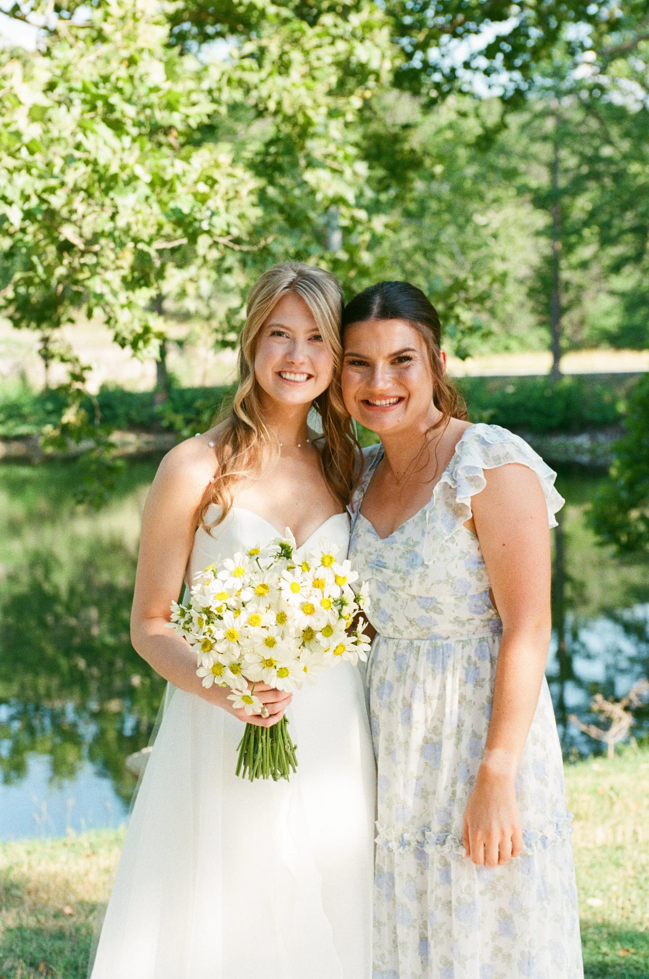 Bride and bridesmaids in pastel mix-and-match gowns with Texas Hill Country lake views at The Preserve