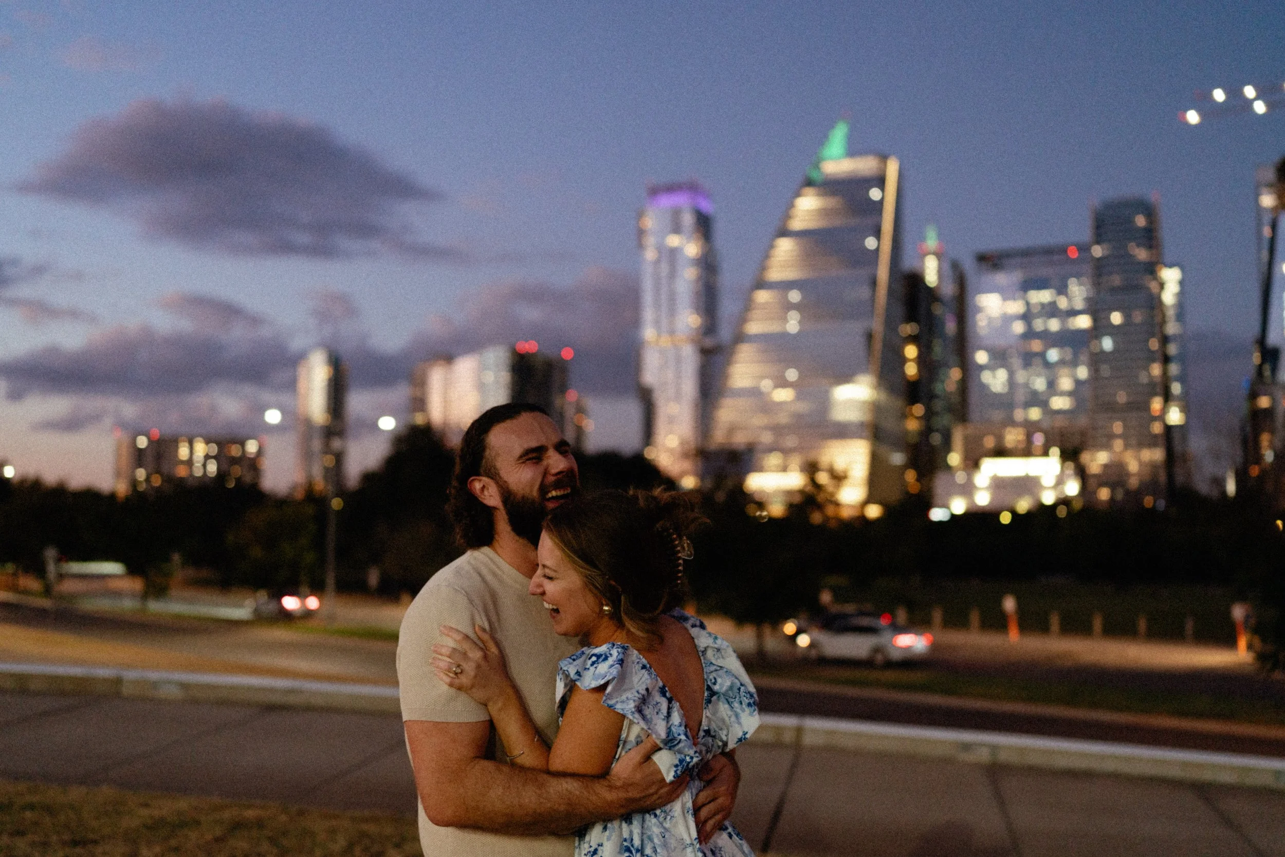 Bride-to-be surprised during proposal at Auditorium Shores with Austin skyline