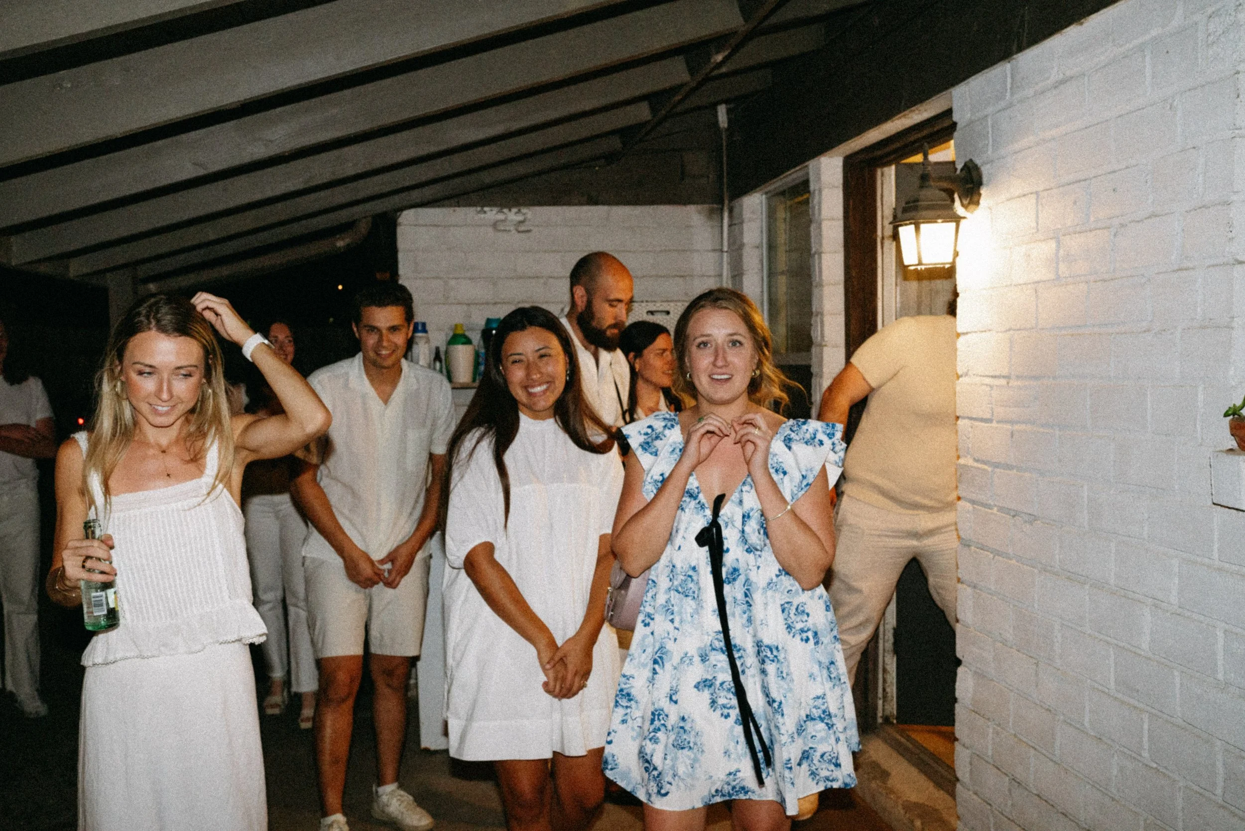 Documentary style wedding photography of couple celebrating engagement with loved ones