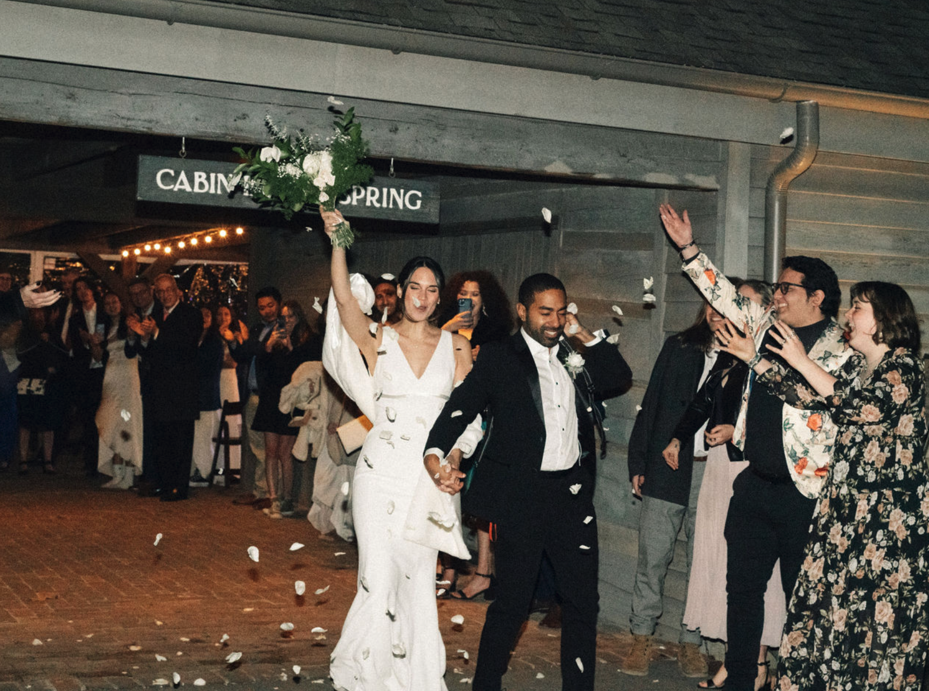 Editorial high flash photo of bride and groom making grand exit