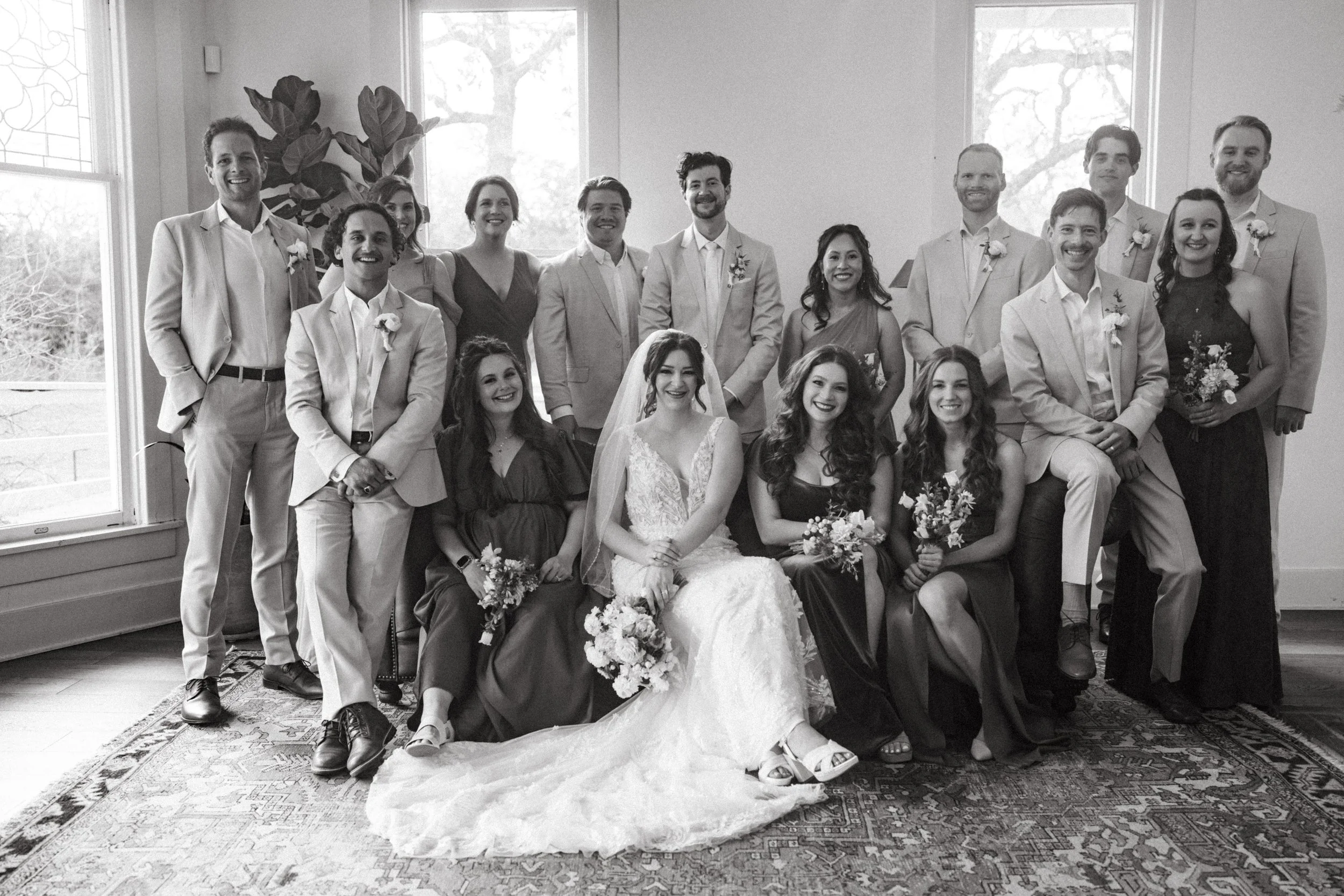 Vogue-style wedding party group photo inside The Grand Lady mansion living room