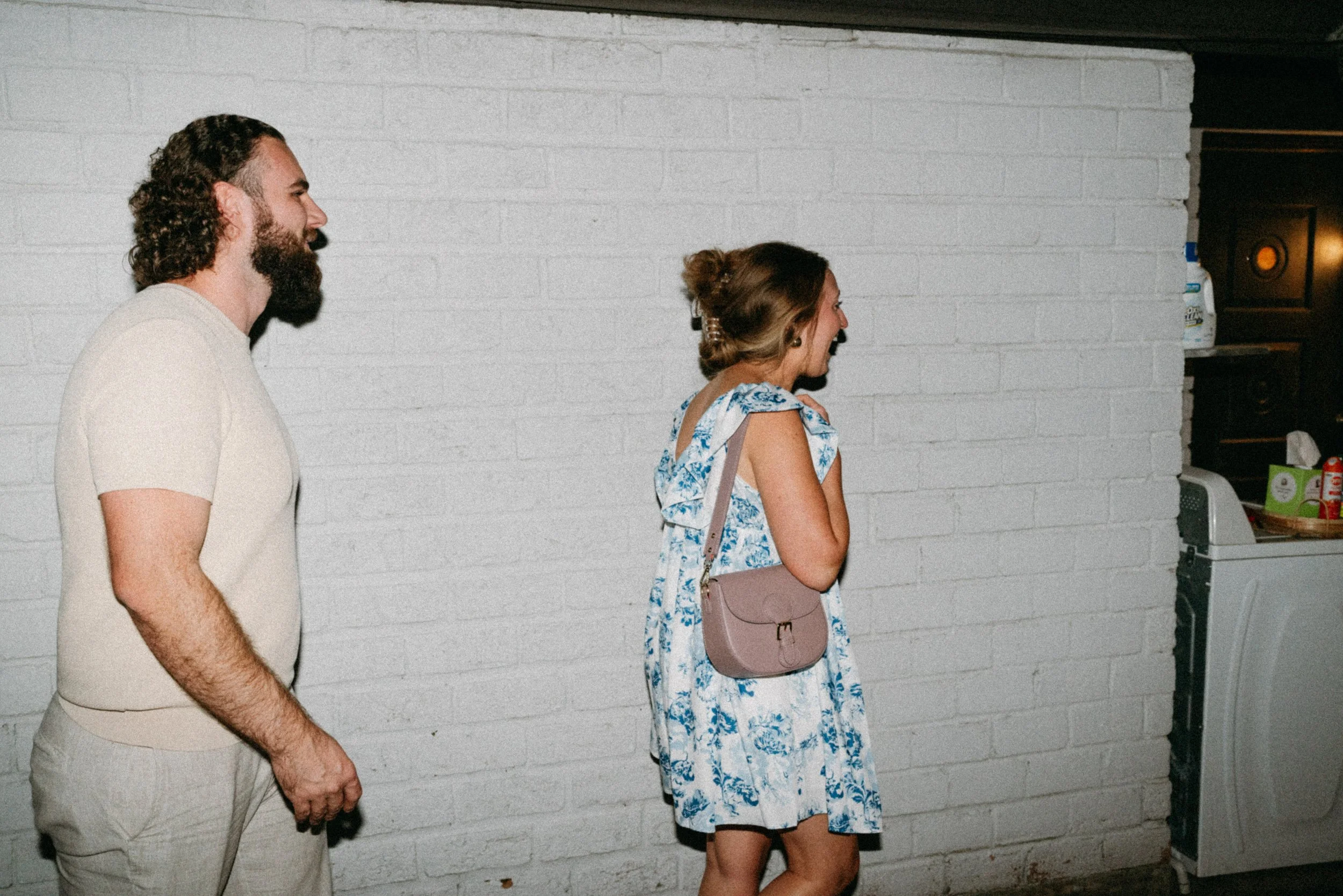 Documentary style wedding photography of couple celebrating engagement with loved ones