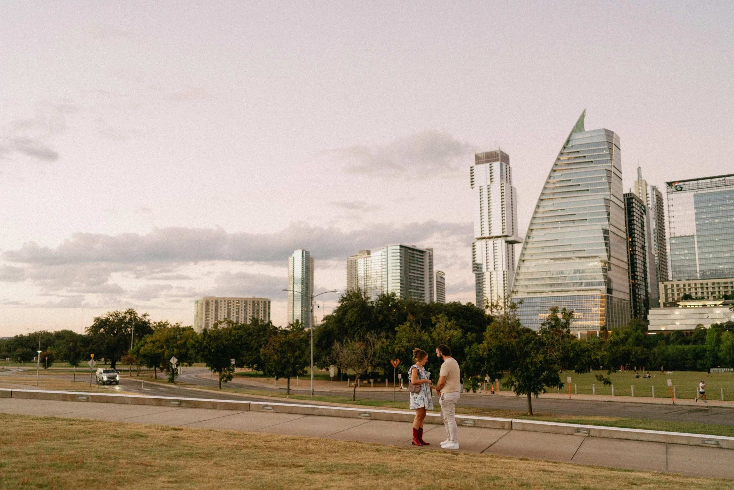 Groom proposing with downtown Austin skyline glowing in the background