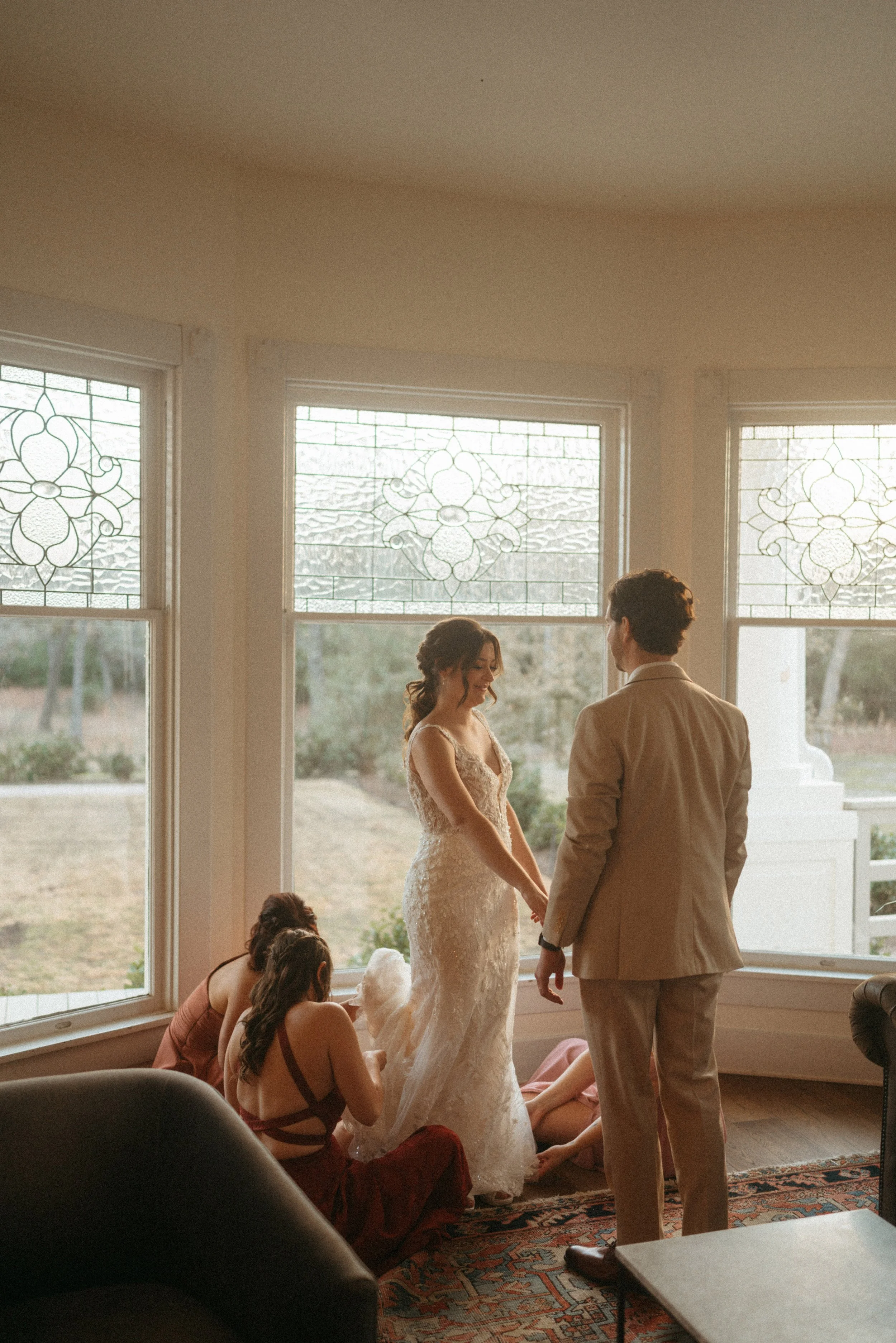 Couple exchanging wedding gifts by the grand windows at The Grand Lady in Austin