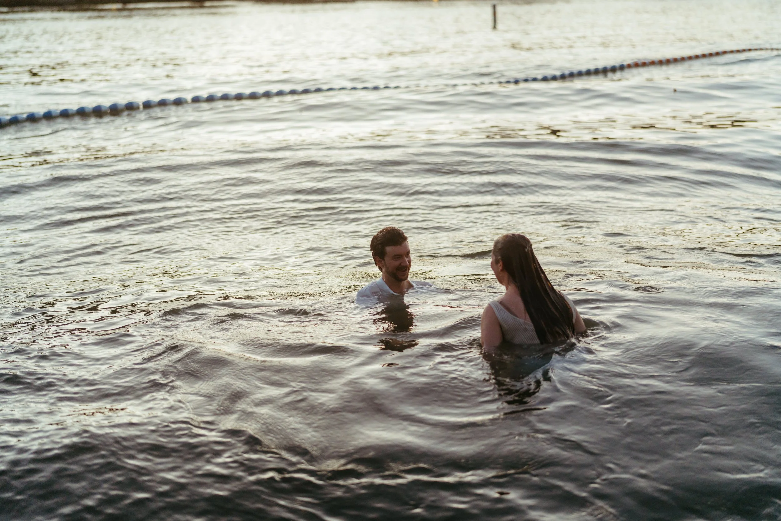 Romantic and candid Austin engagement photography with couple in the water