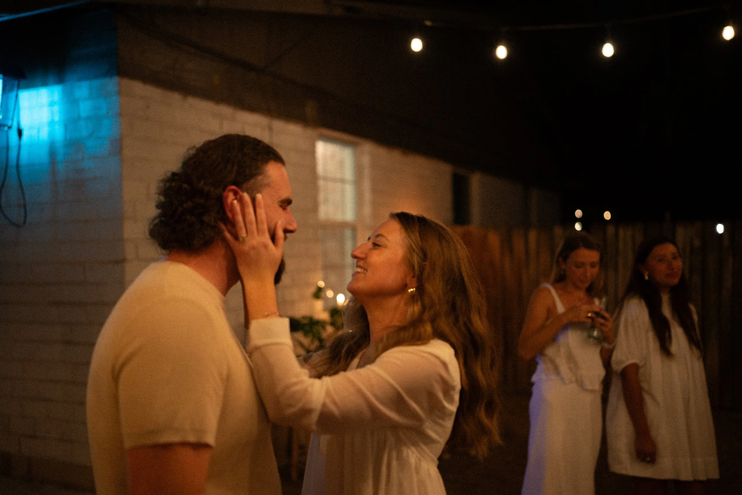 Documentary style wedding photography of couple celebrating engagement with loved ones