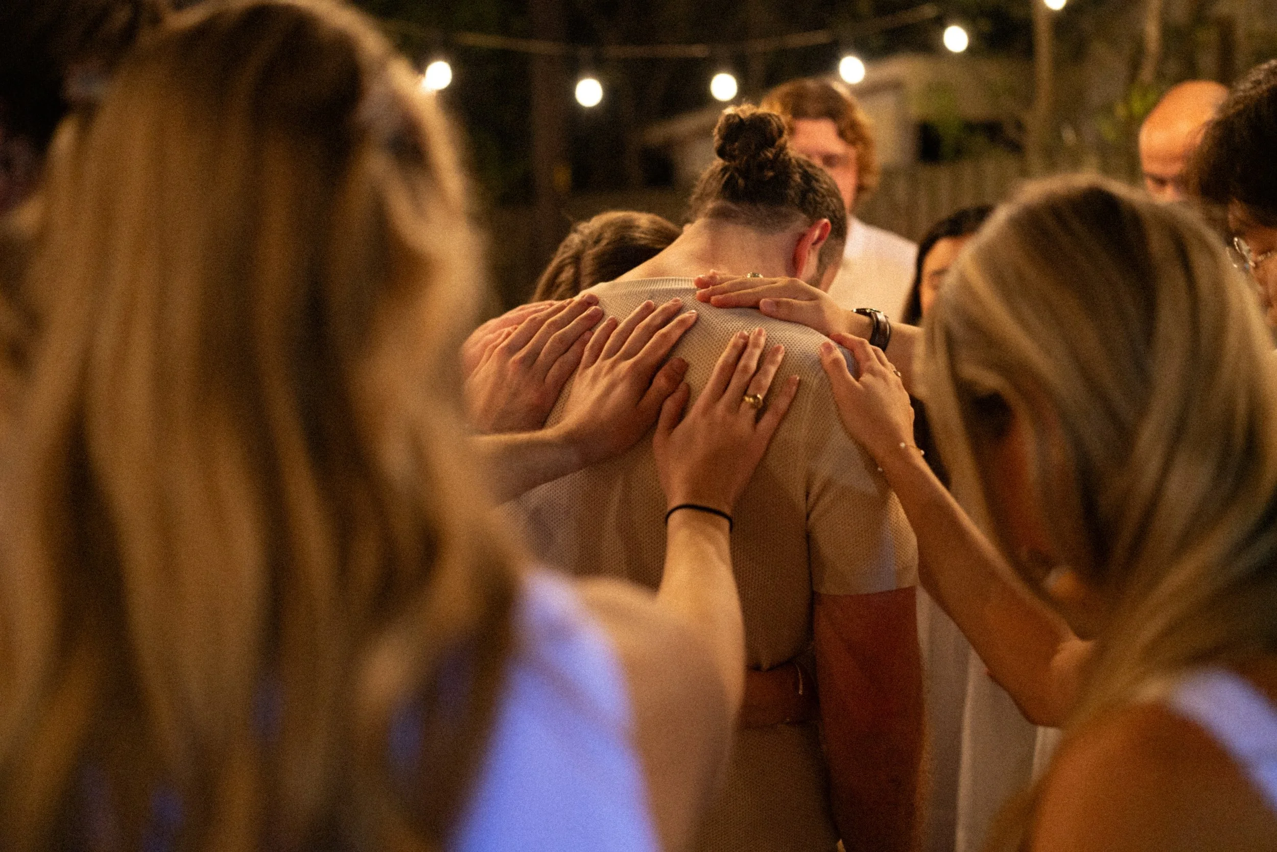 Documentary style wedding photography of couple celebrating engagement with loved ones