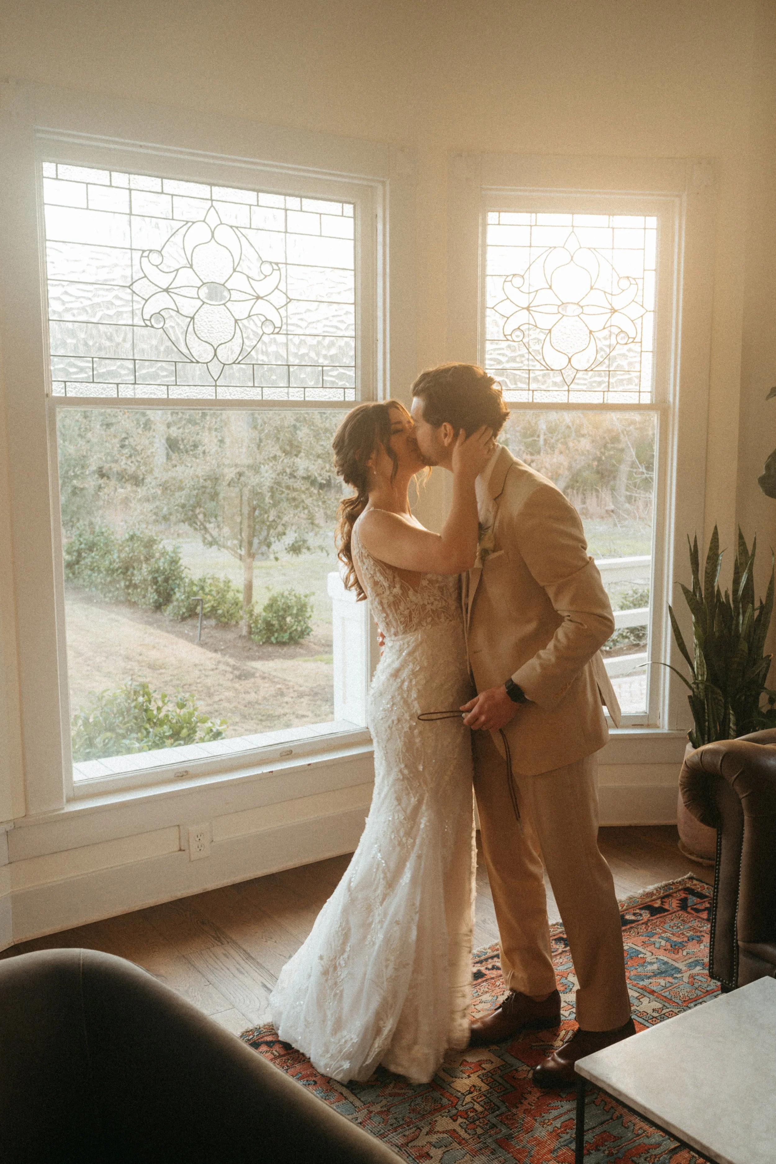 Couple exchanging wedding gifts by the grand windows at The Grand Lady in Austin