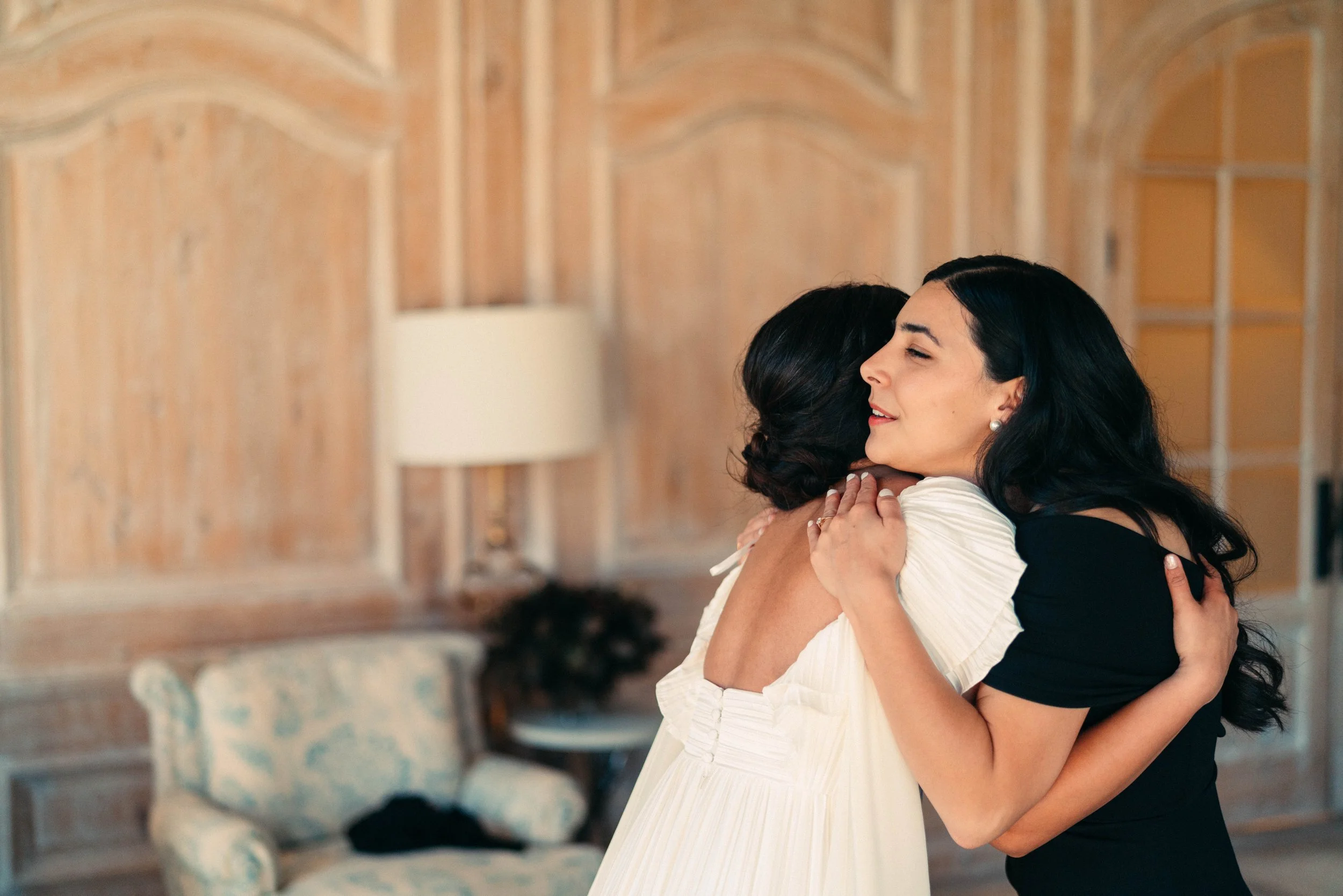 Bride sharing first look with bridesmaids in classic bridesmaids dresses at Houston Oaks Country Club and Retreat