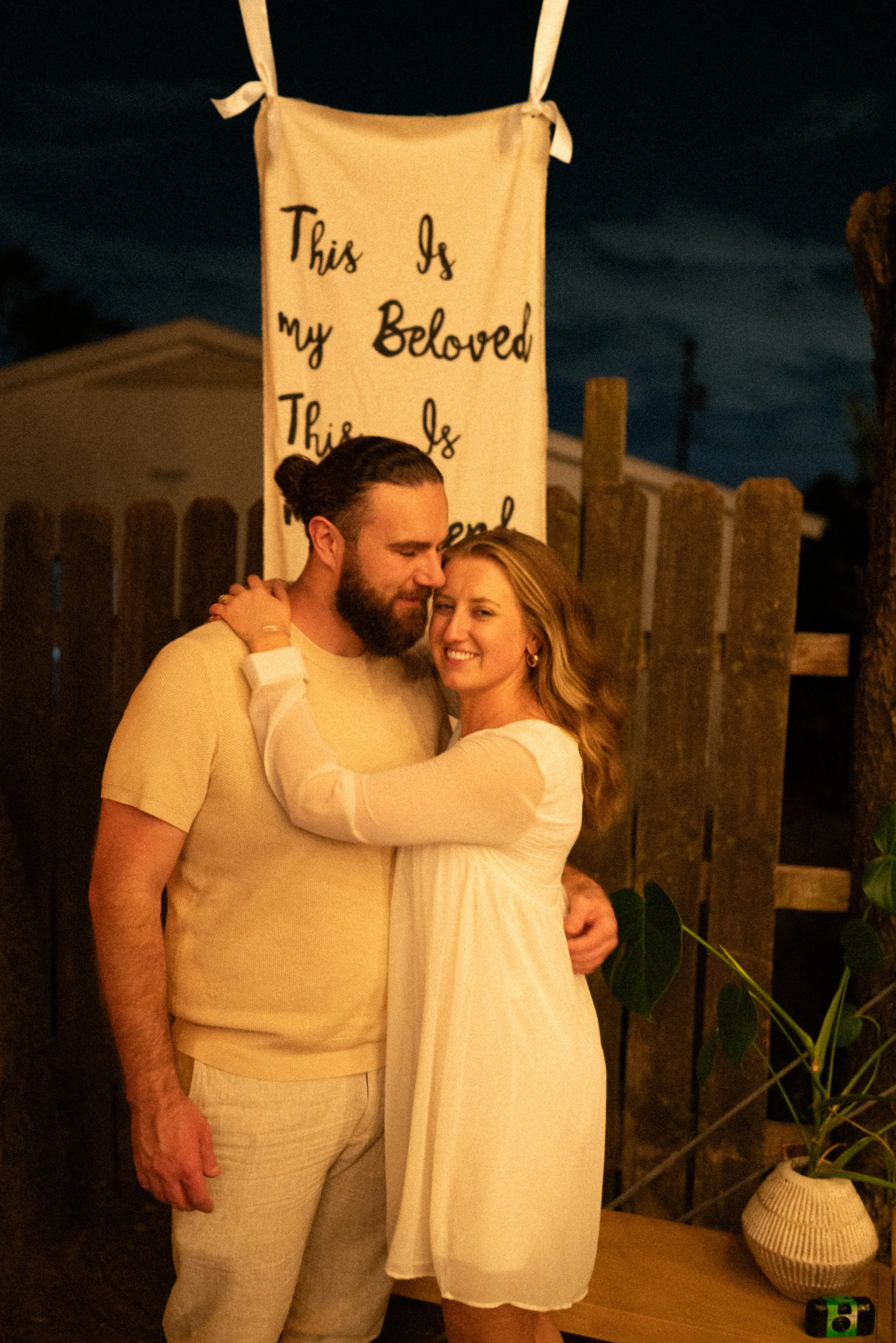 Documentary style wedding photography of couple celebrating engagement with loved ones