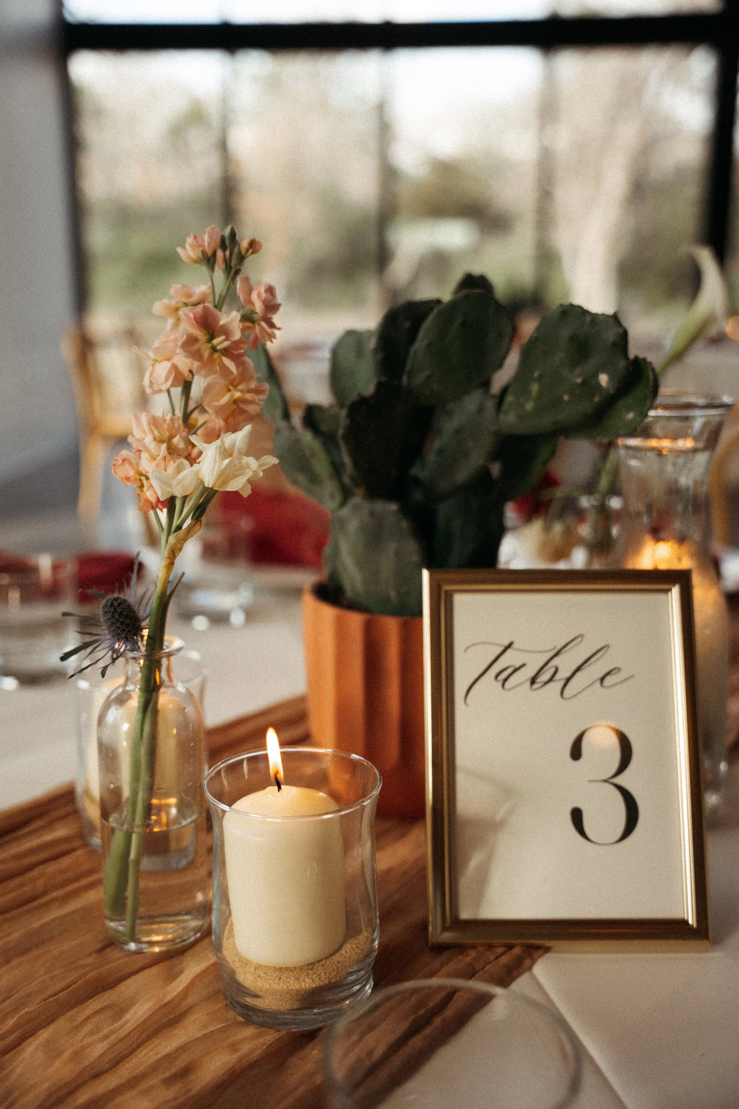 desert inspired floral centerpiece and candles at The Grand Lady wedding reception hall