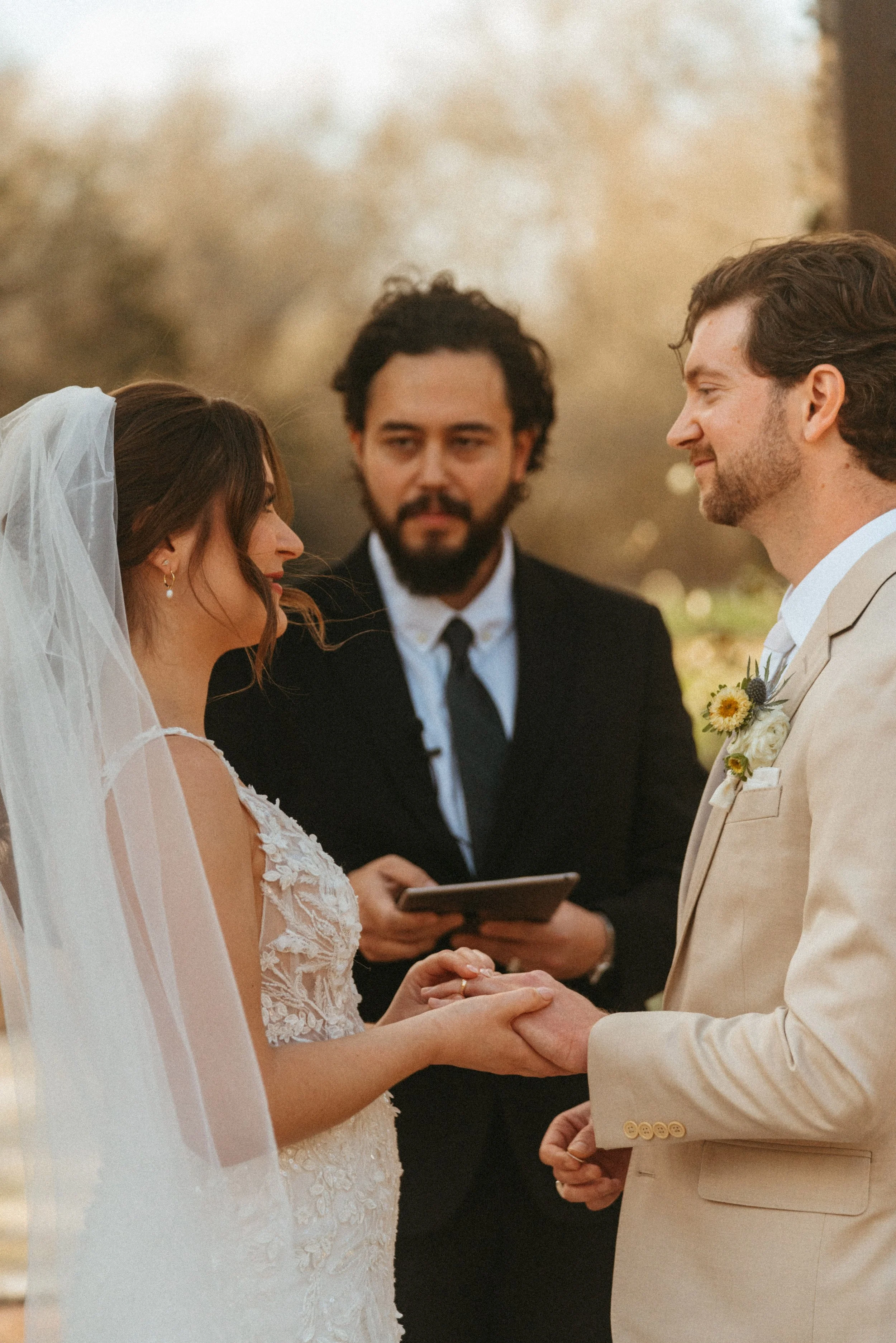 Bride and groom exchange vows under the pergola in The Grand Lady flower garden in Manor, TX