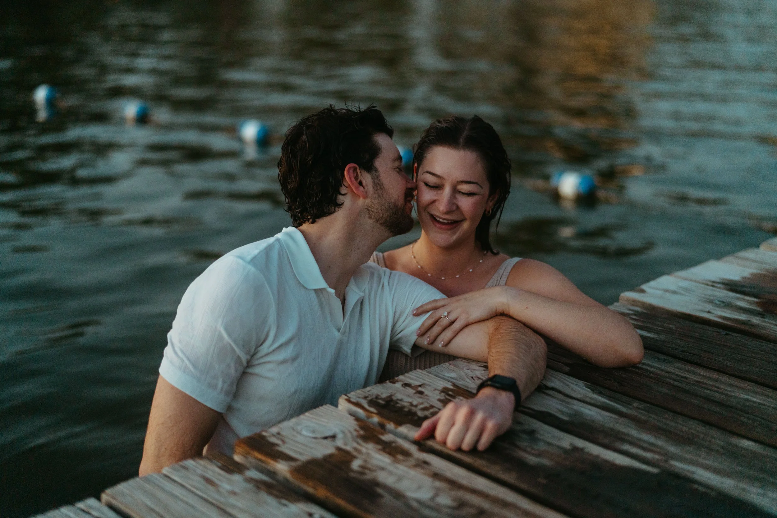 Couple kissing in the lake at Emma Long Park during Austin sunset proposal photography