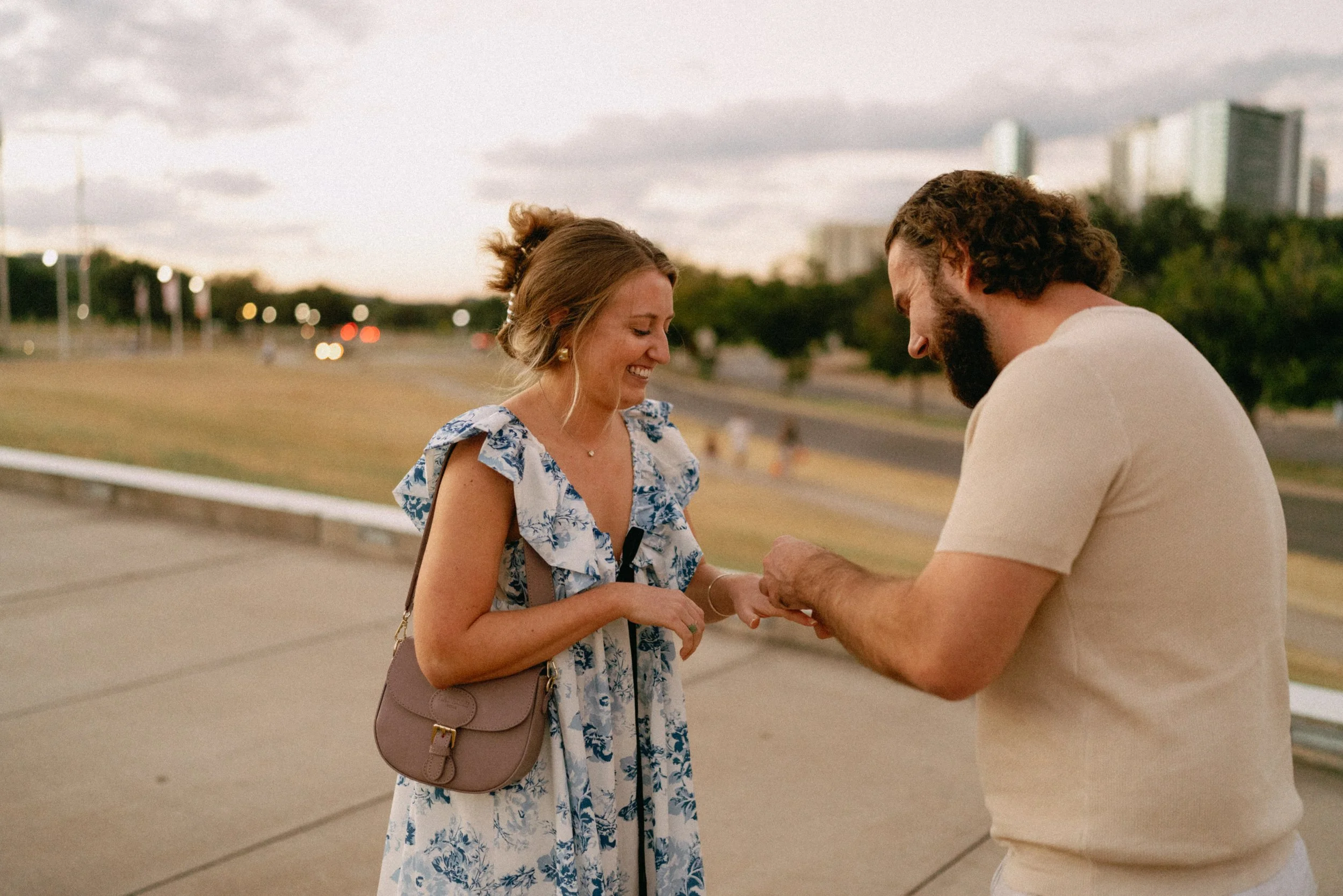 Sunset proposal at Auditorium Shores in Austin captured by documentary style wedding photographer