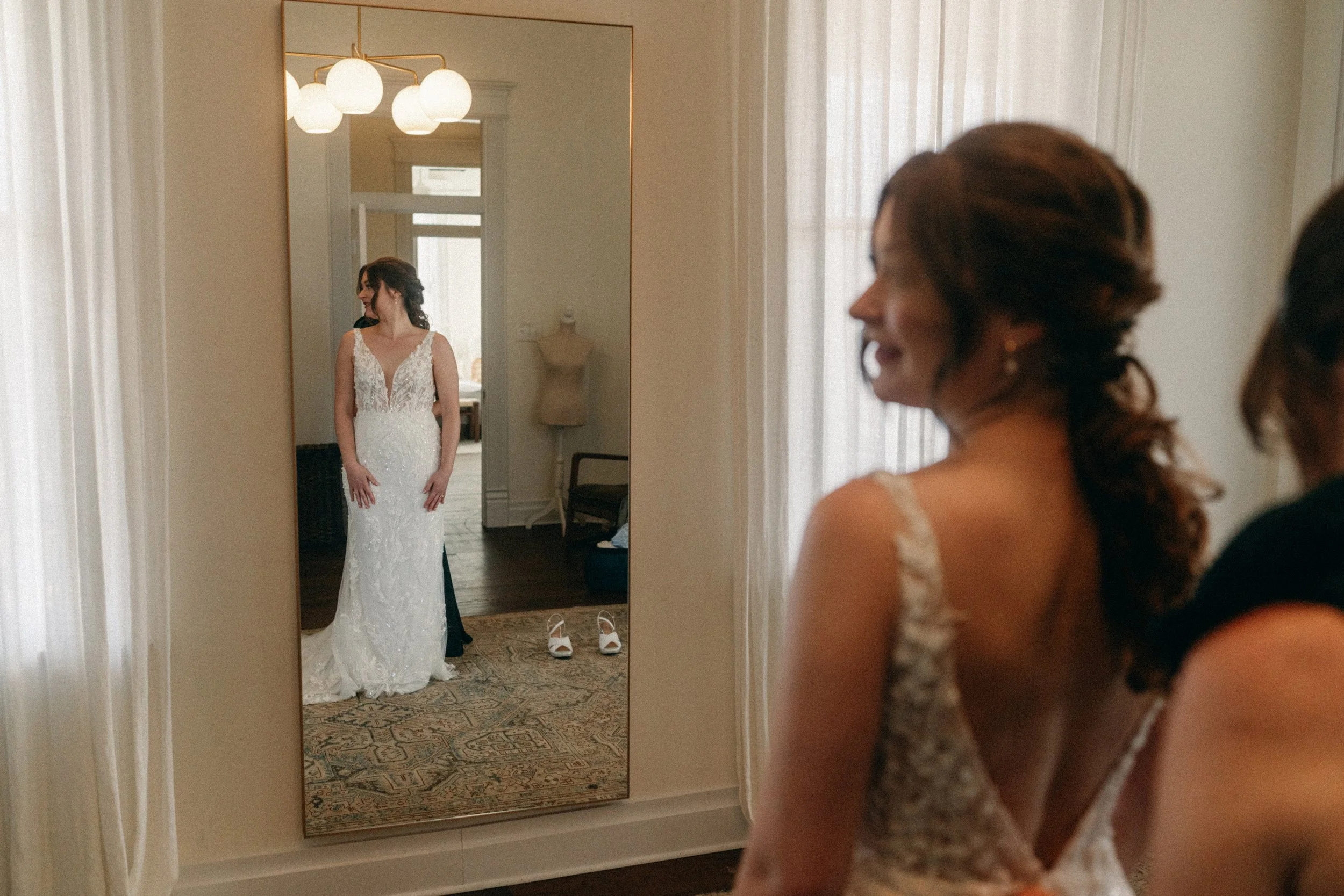 Mother of the Bride getting helping bride get into her bridal gown in mansion suite at The Grand Lady in manor tx just outside of austin