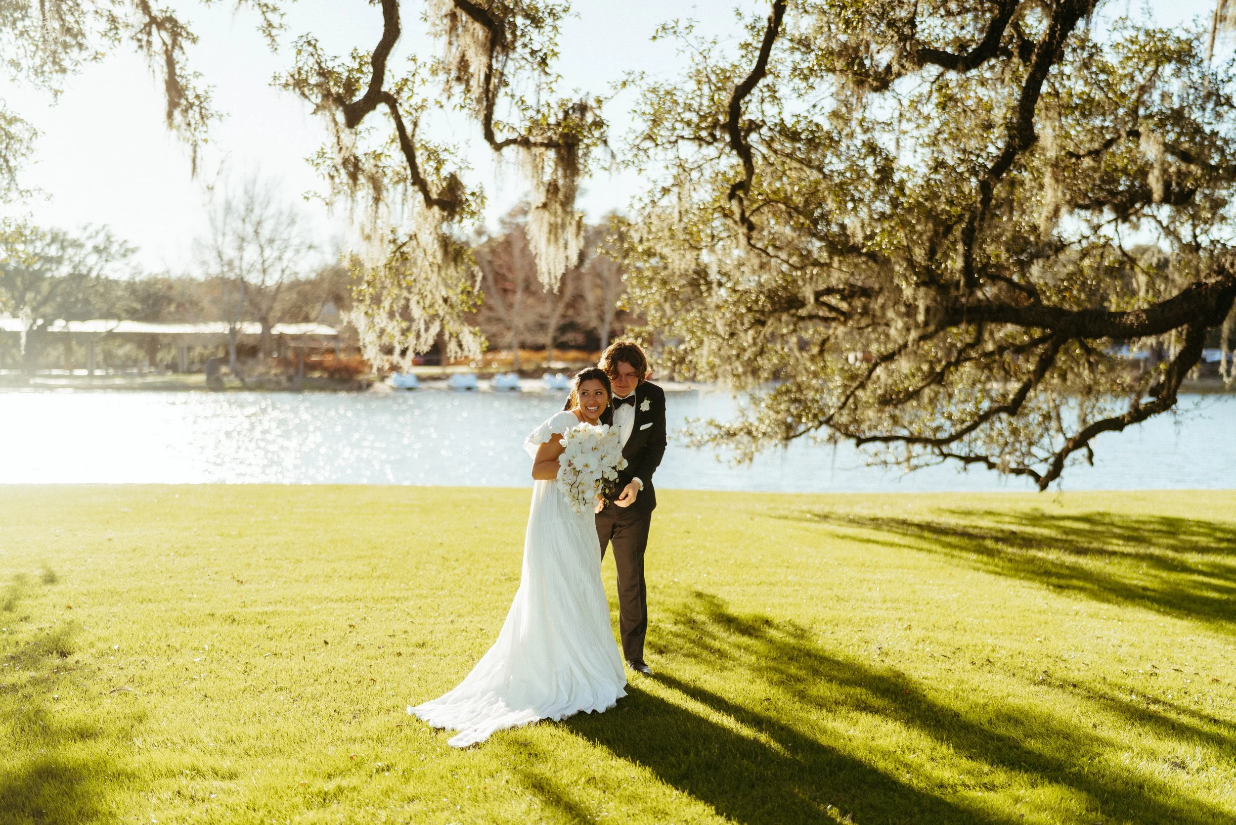 Newlyweds walking hand in hand near the historic French chapel | Austin travel wedding photographer.