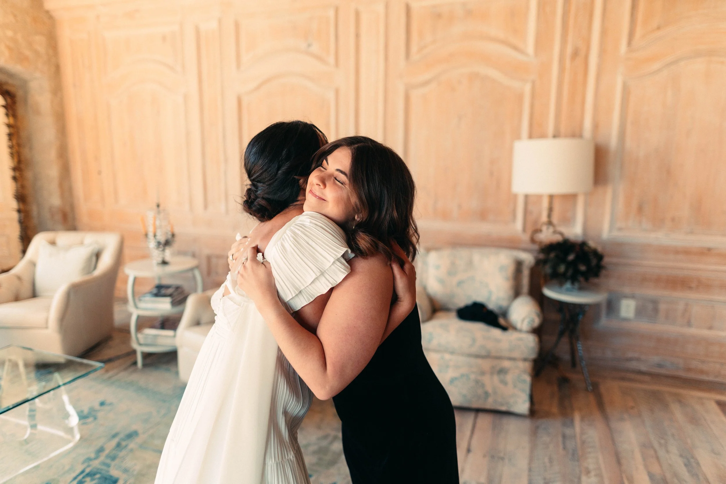 Bride sharing an emotional first look with her bridesmaids at Houston Oaks | documentary Austin travel wedding photographer.