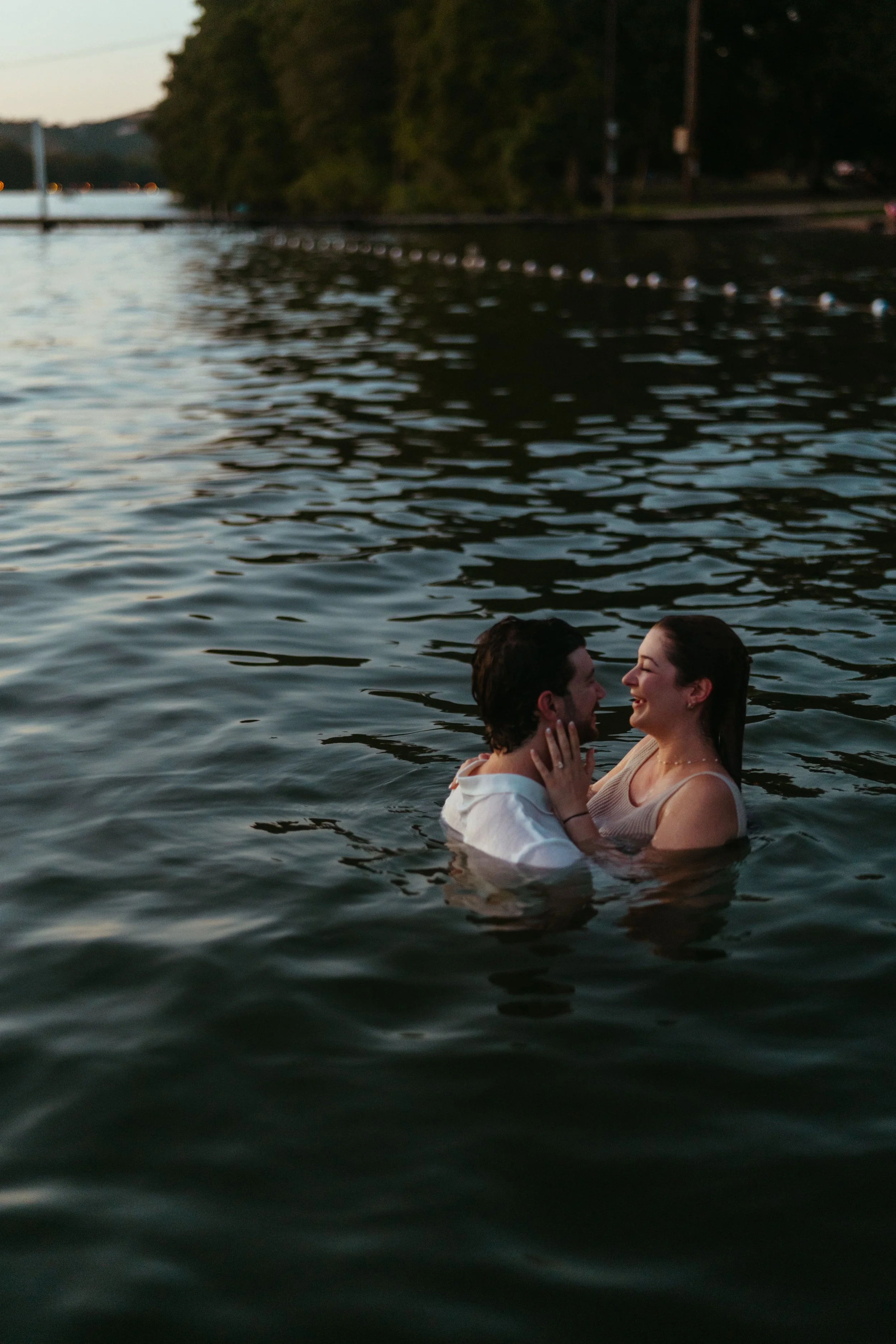 Playful Austin wedding photography with couple celebrating in the water