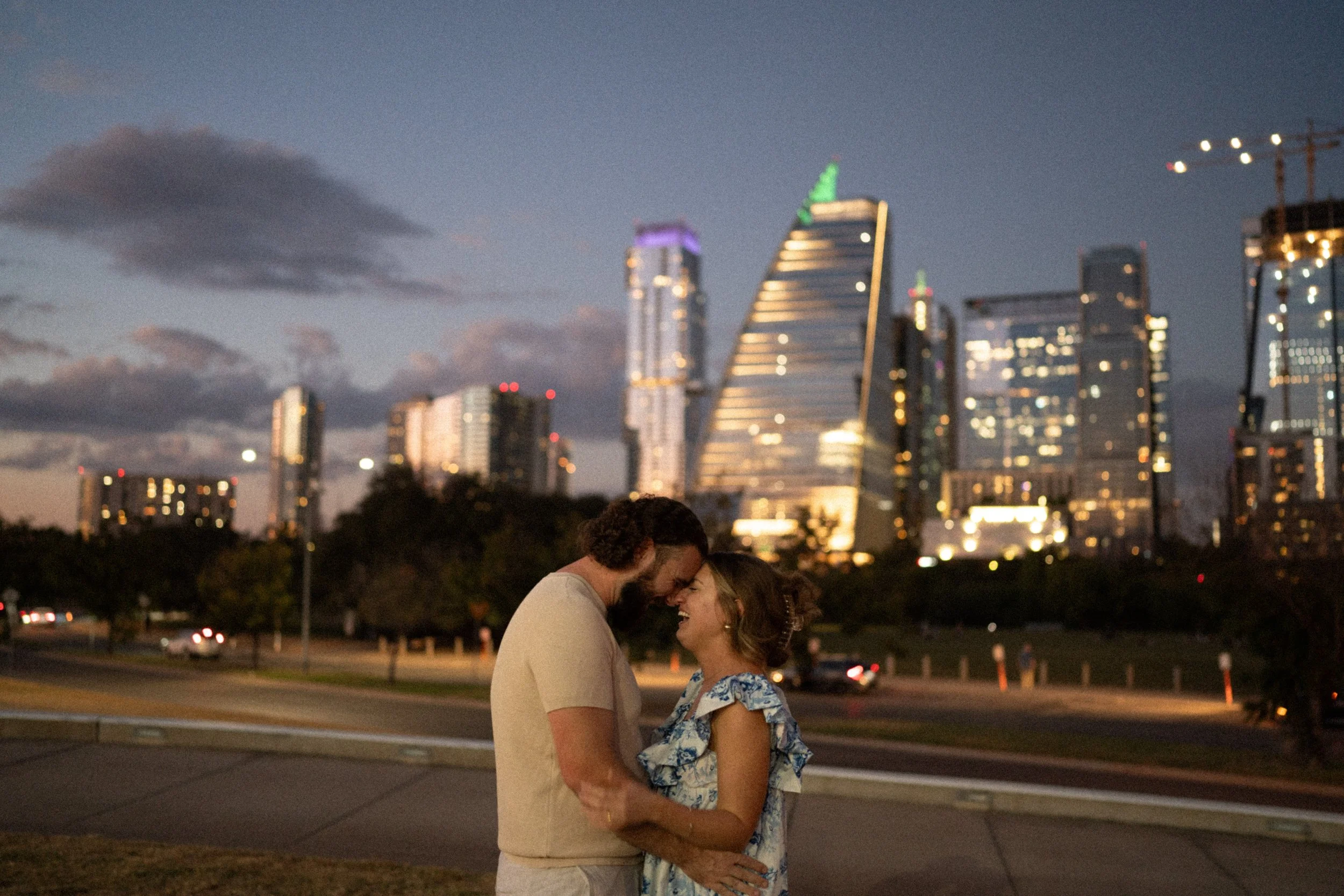 Bride-to-be surprised during proposal at Auditorium Shores with Austin skyline