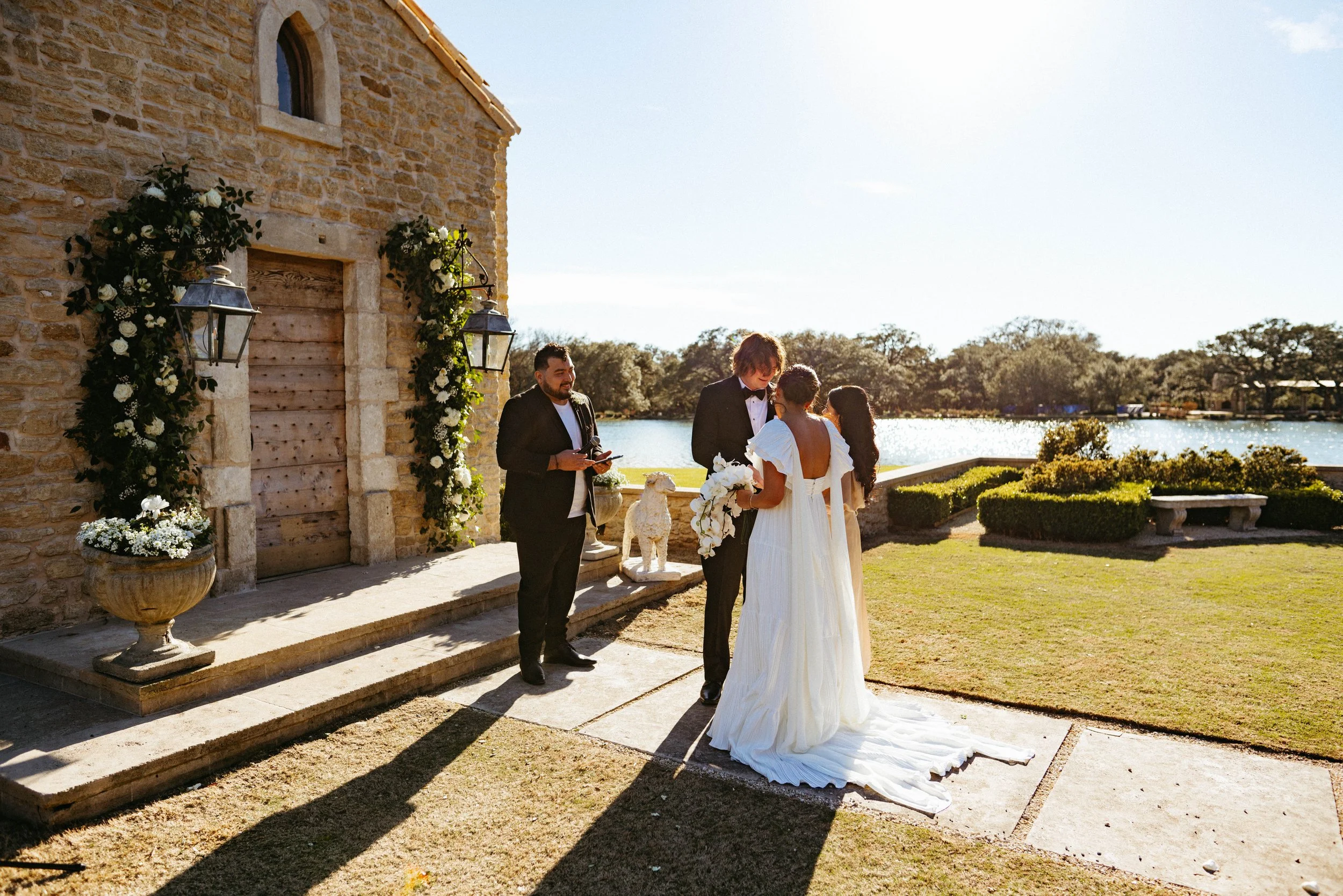 Couple embracing outside the Houston Oaks French chapel before their vows.