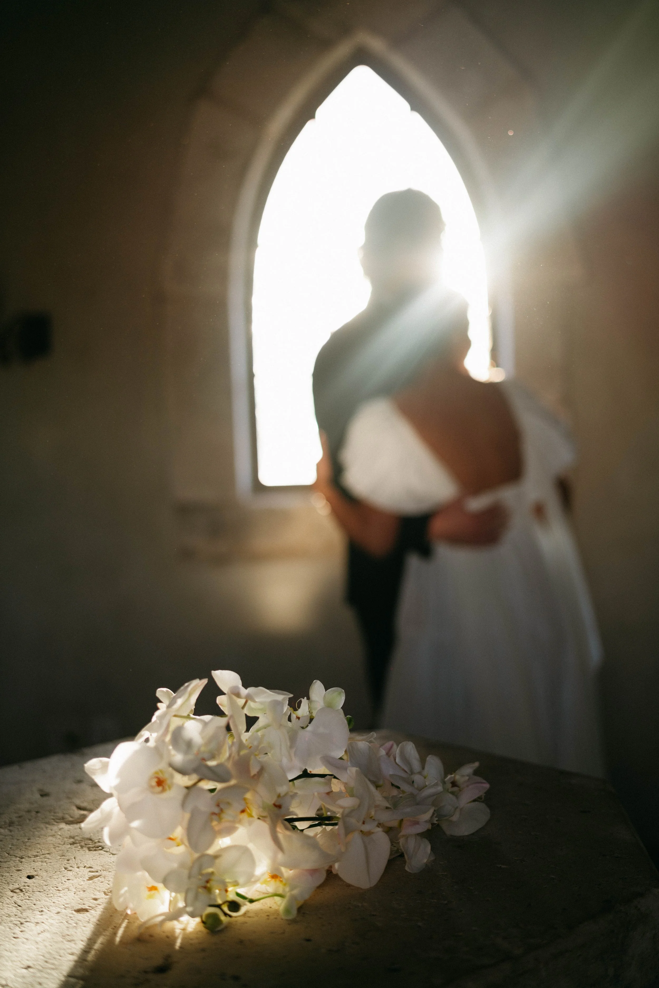 Couple embracing inside the Houston Oaks French chapel after their vows.