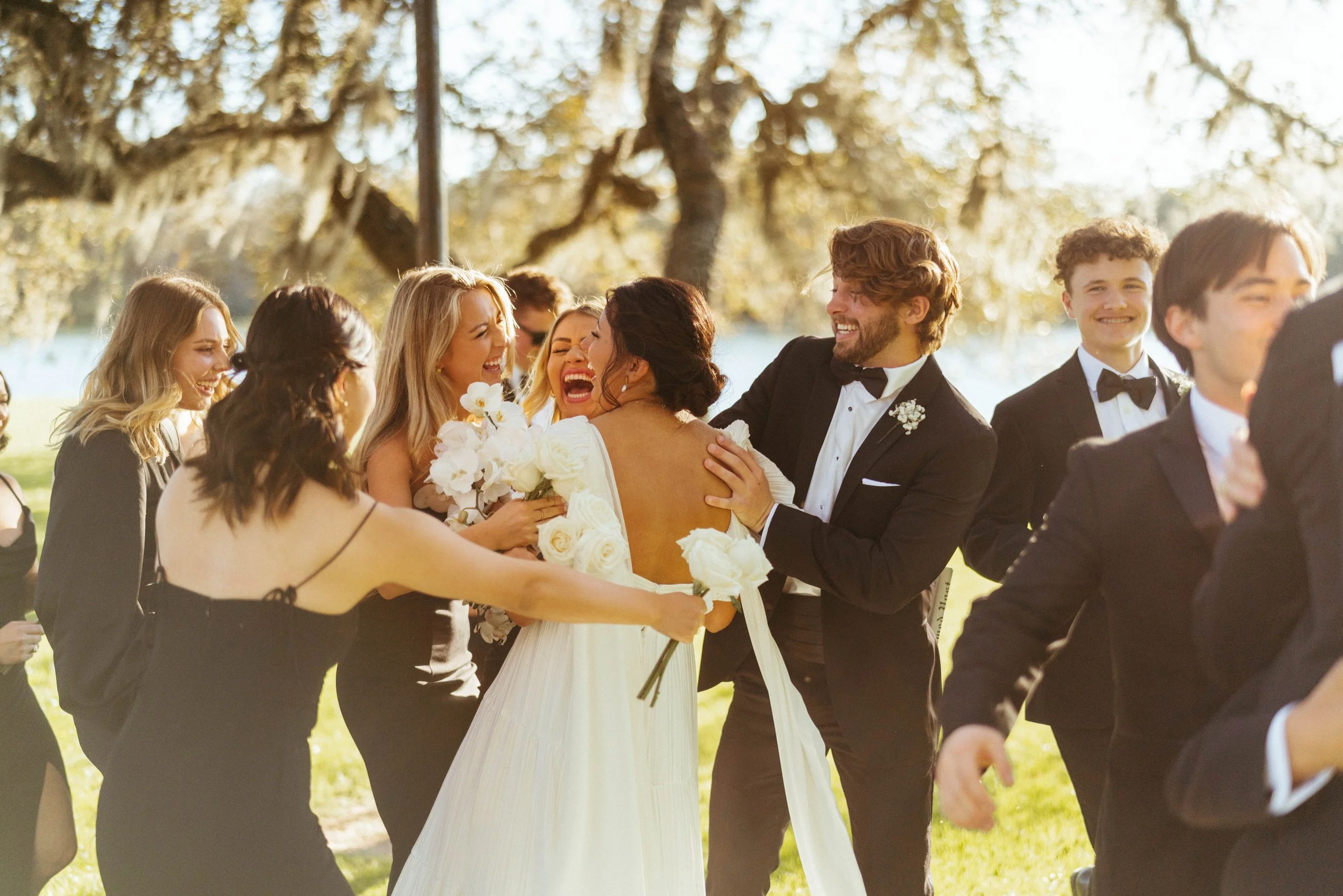 Wedding party laughing together during Houston Oaks wedding portraits | Austin travel wedding photographer.