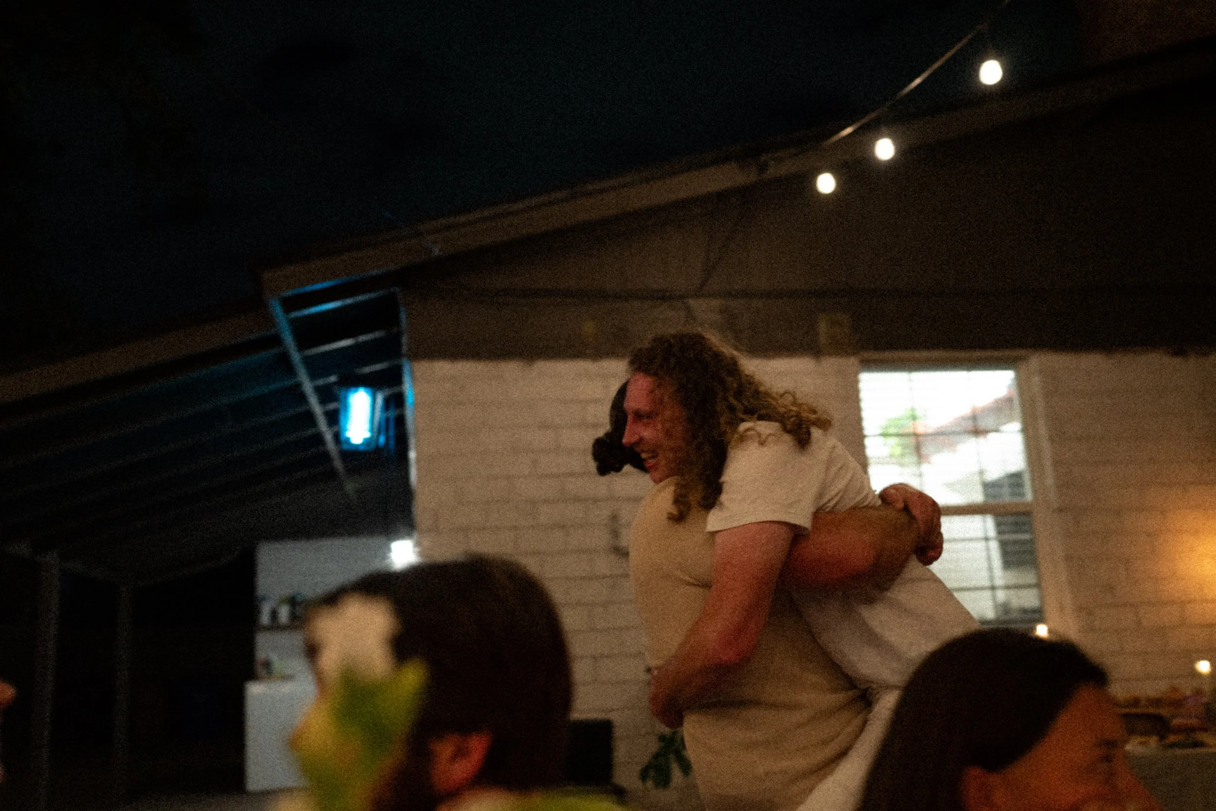 Documentary style wedding photography of couple celebrating engagement with loved ones
