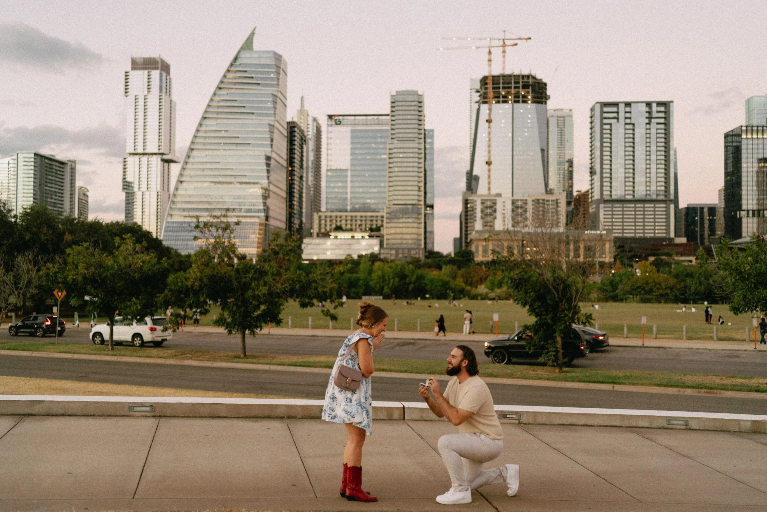 Groom proposing with downtown Austin skyline glowing in the background