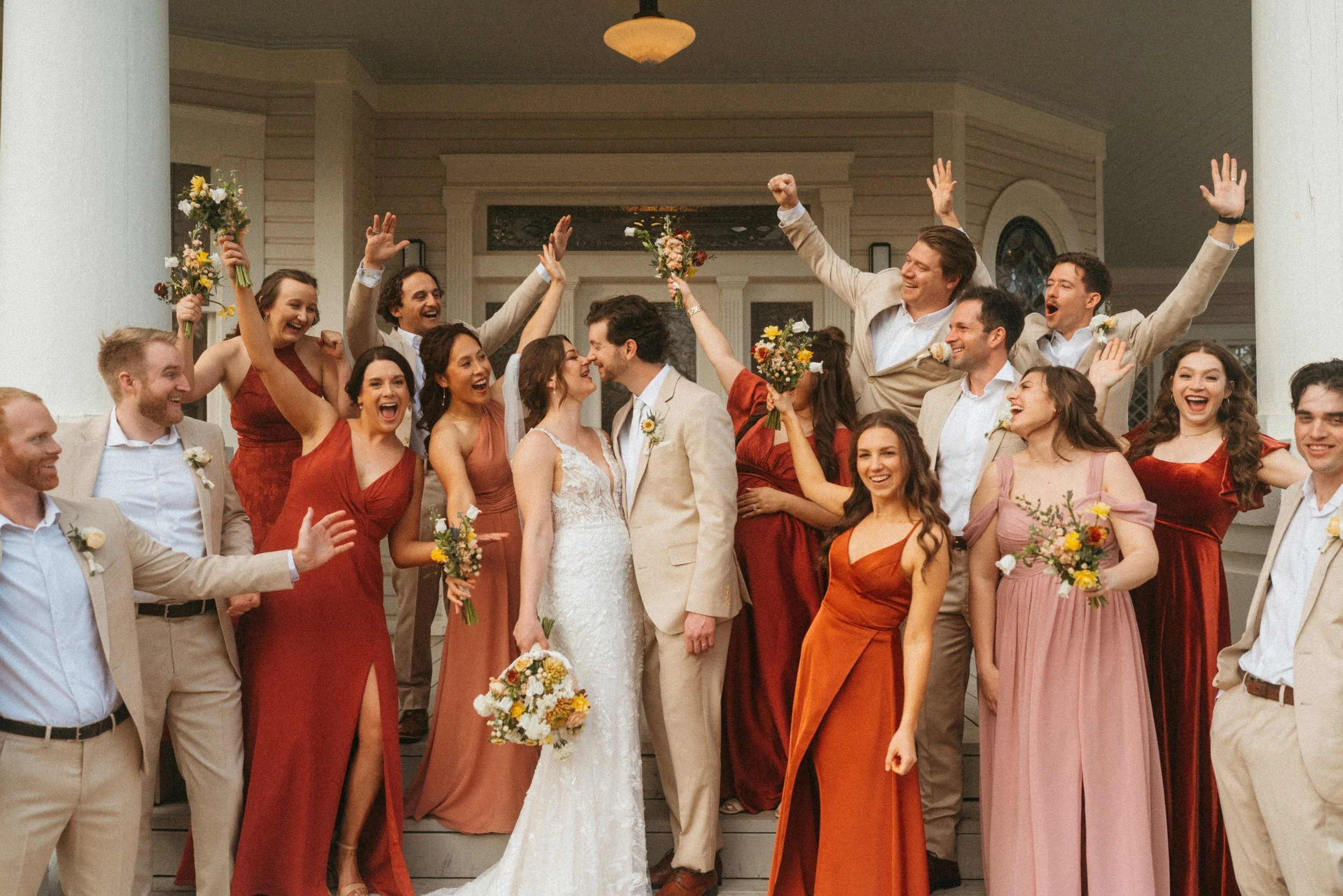 Candid Fun wedding party group photo on The Grand Lady mansion porch