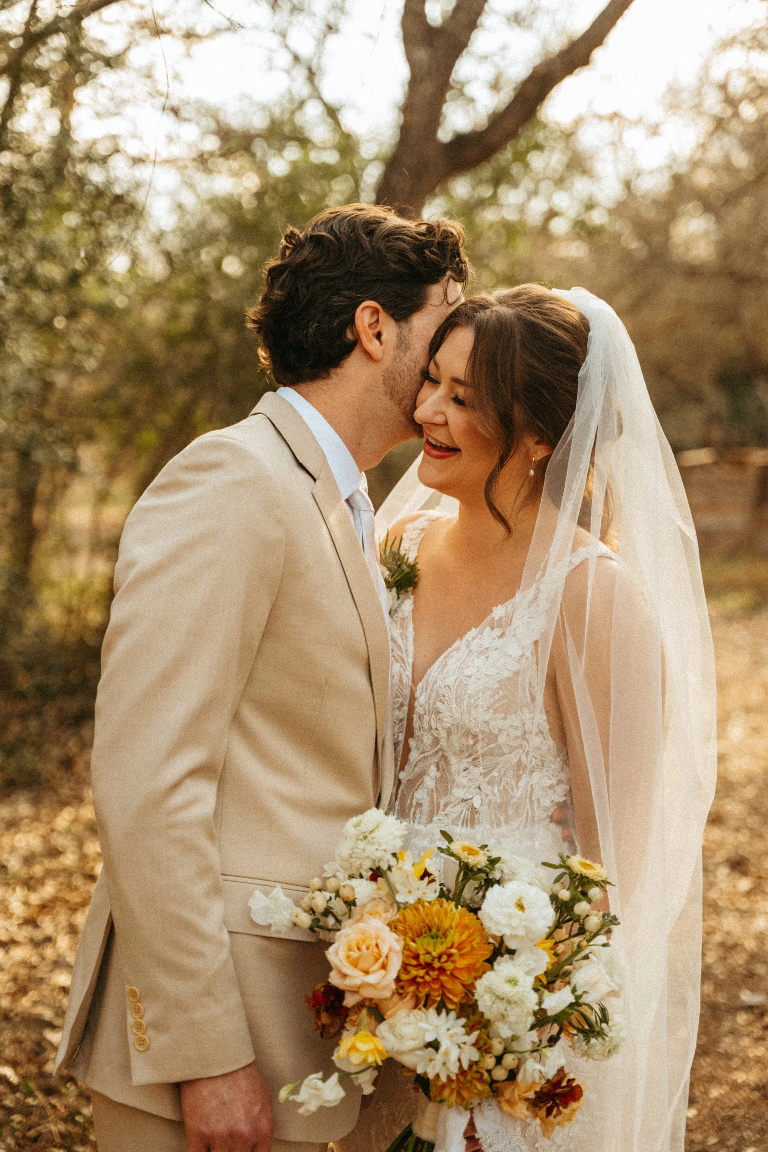 Bride and groom walking hand in hand down oak-lined path at The Grand Lady Manor TX