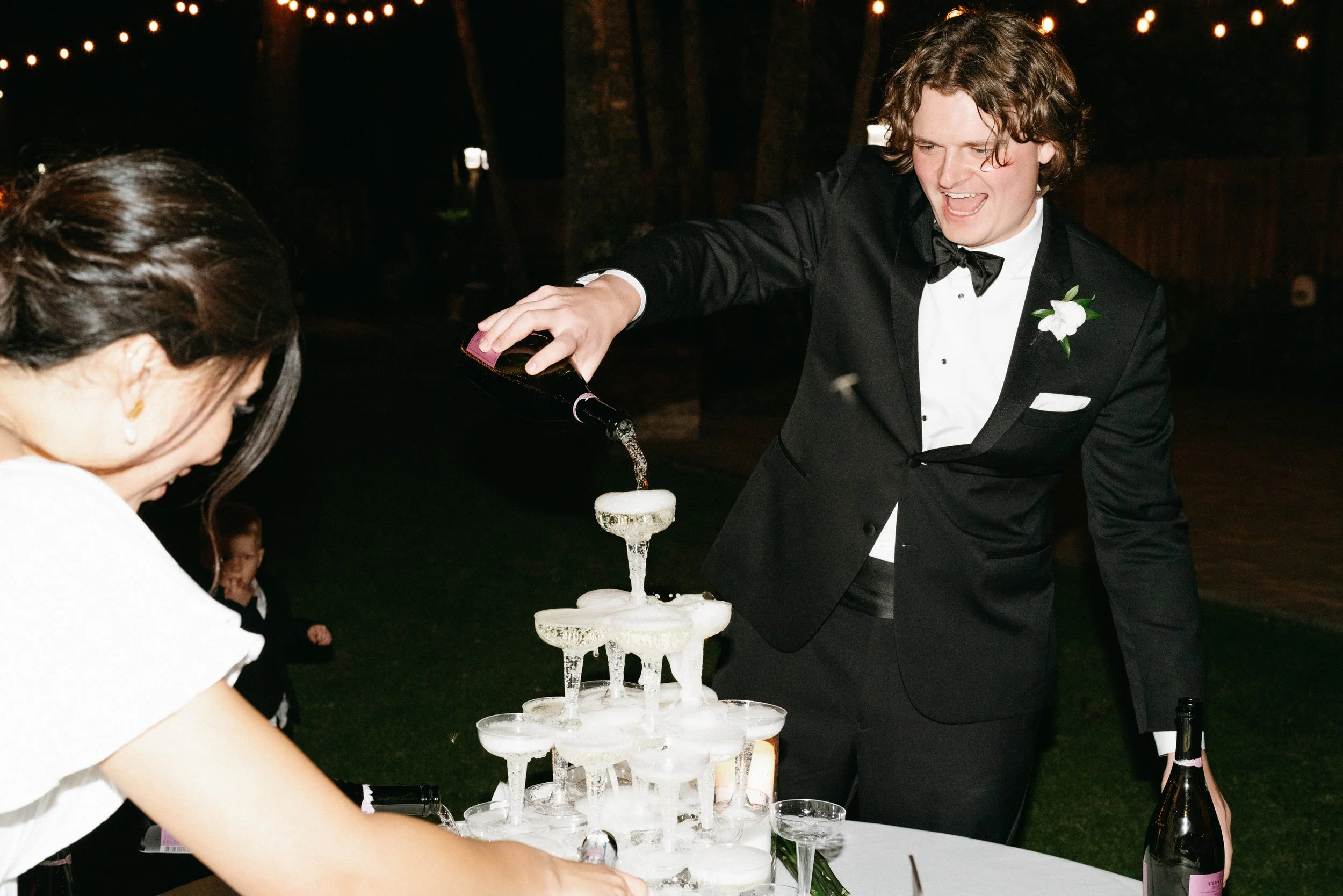 Austin Bride and groom pouring champagne tower at oaktree manor | Houston travel wedding
