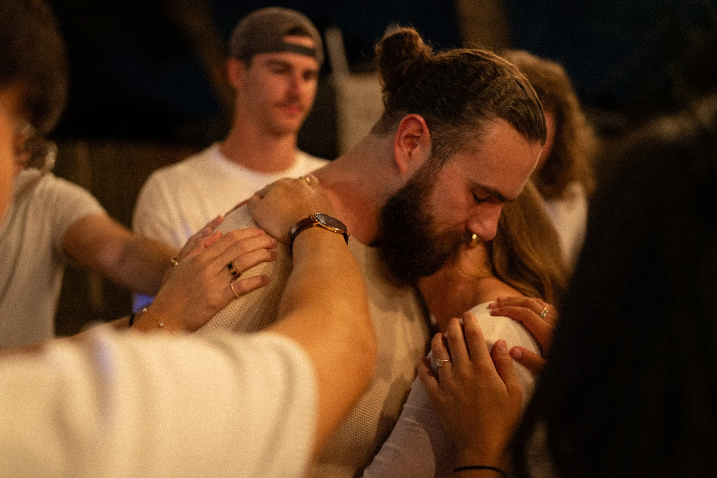 Documentary style wedding photography of couple celebrating engagement with loved ones